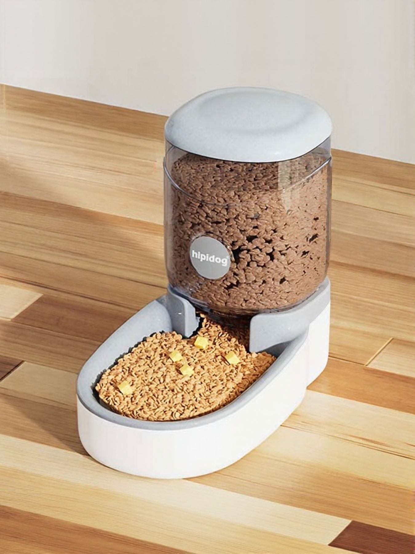 Light gray automatic pet food dispenser with clear container and white feeding base