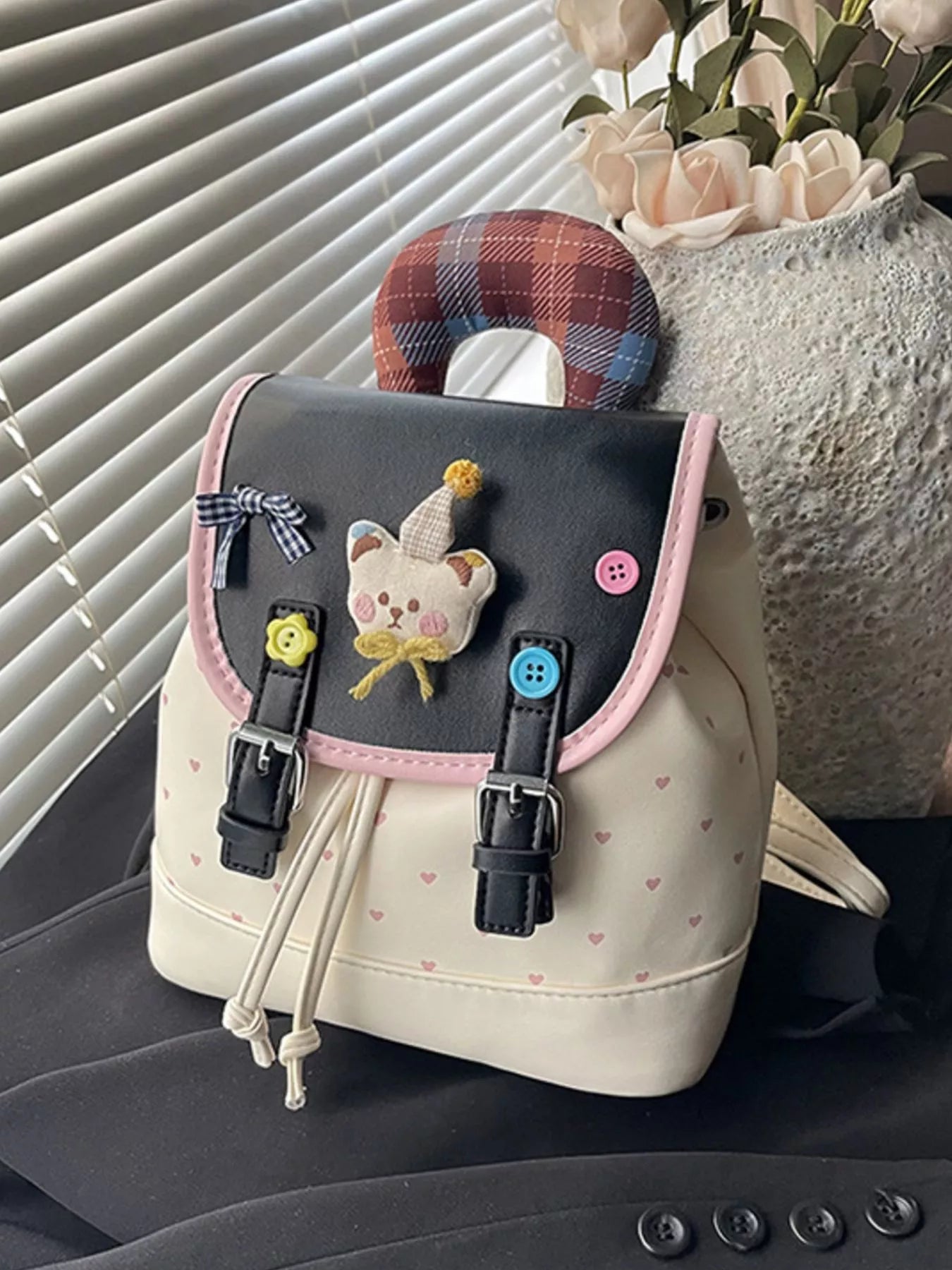 Beige cartoon bear backpack with pink trim, front pocket patch and buckle straps