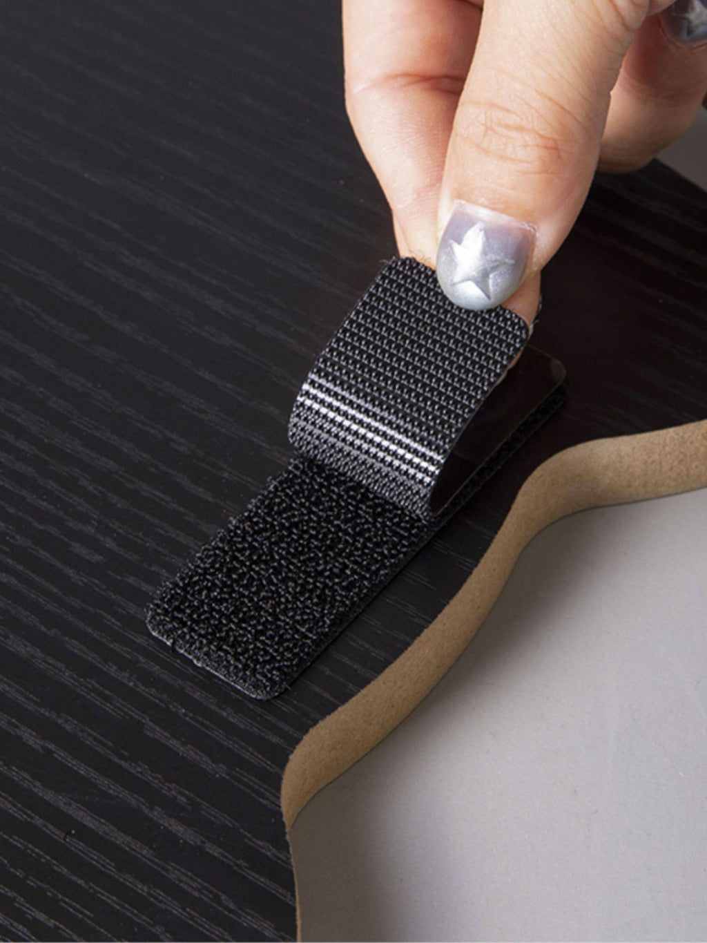 Close-up of scratching surface replacing pad: dark woven fabric with edges