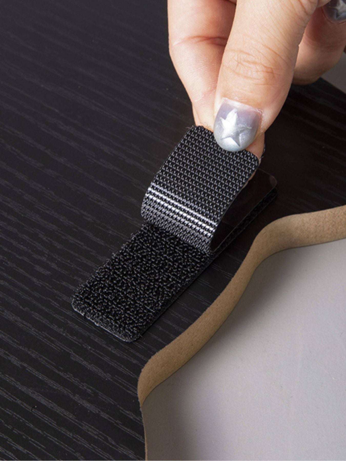 Close-up of scratching surface replacing pad: dark woven fabric with edges
