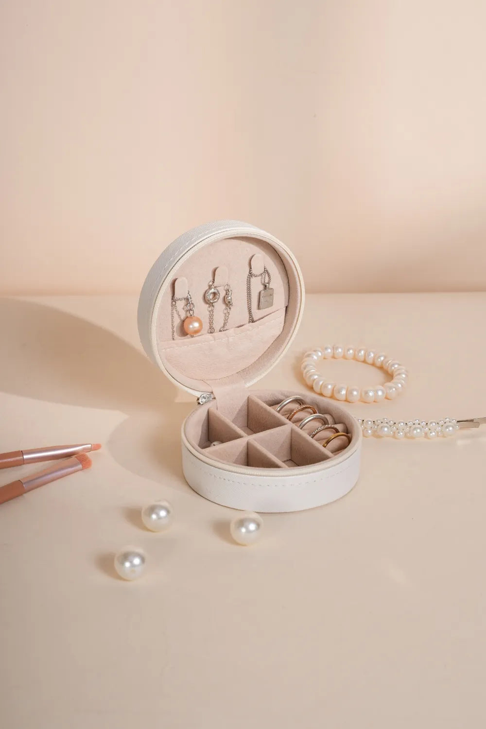 Beige PU leather jewelry box with round open lid and divided ring storage trays