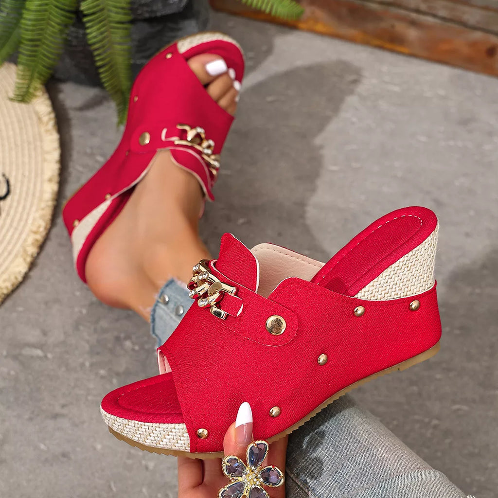 Rose red open-toe wedge sandals with front strap, stud accents, and metal chain hardware