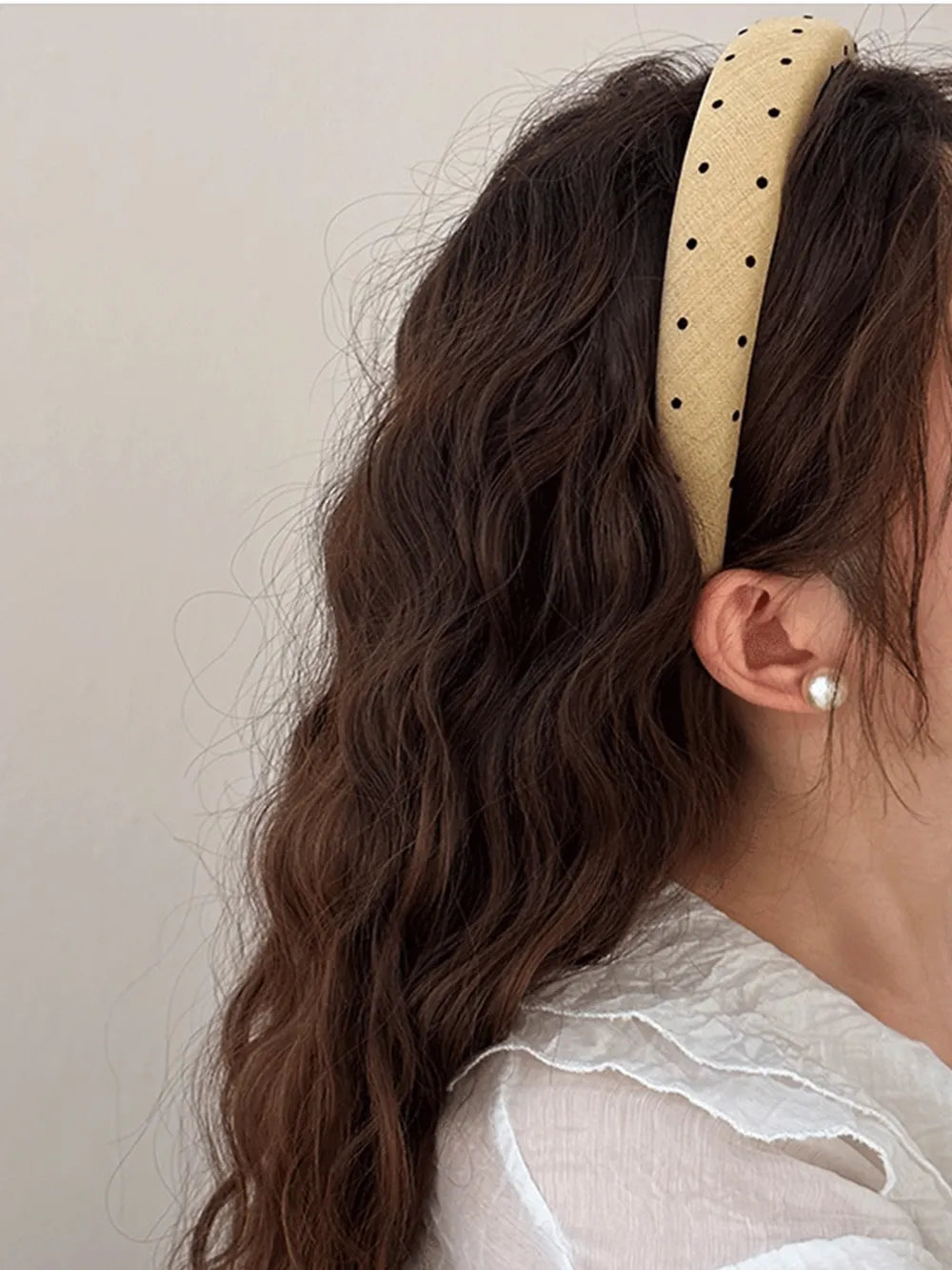 Camel polka dot wide headband worn on hair, black dot pattern