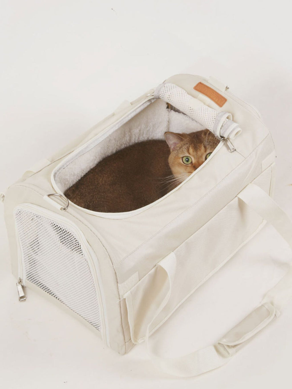 Pet carrier bag with liner and top opening, plush interior and mesh side, white.