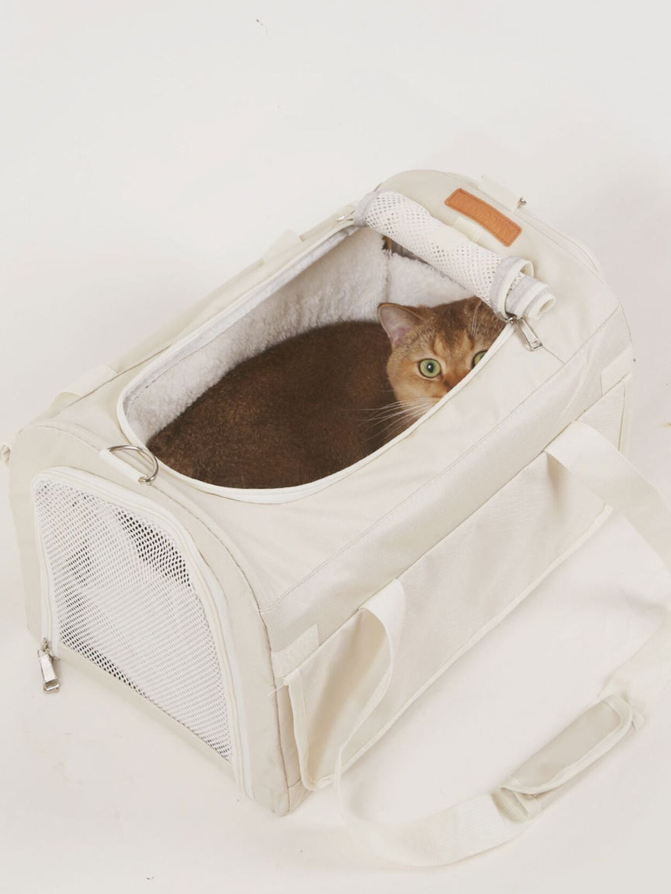 Pet carrier bag with liner and top opening, plush interior and mesh side, white.