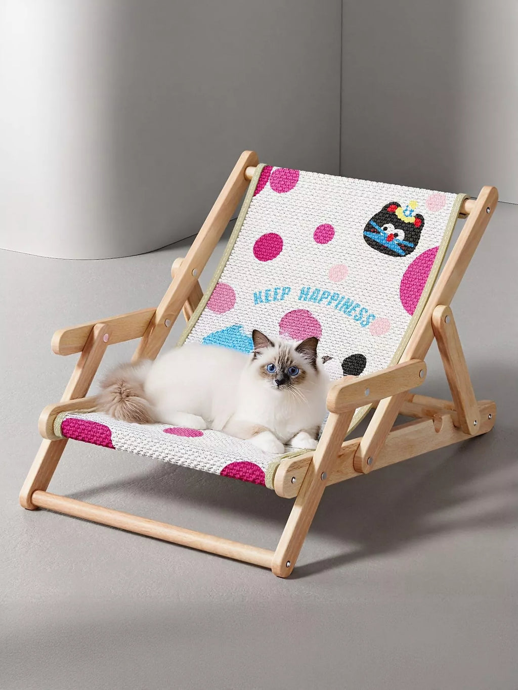 Wooden pet chair with polka dot black cat pattern, featuring a lying kitten