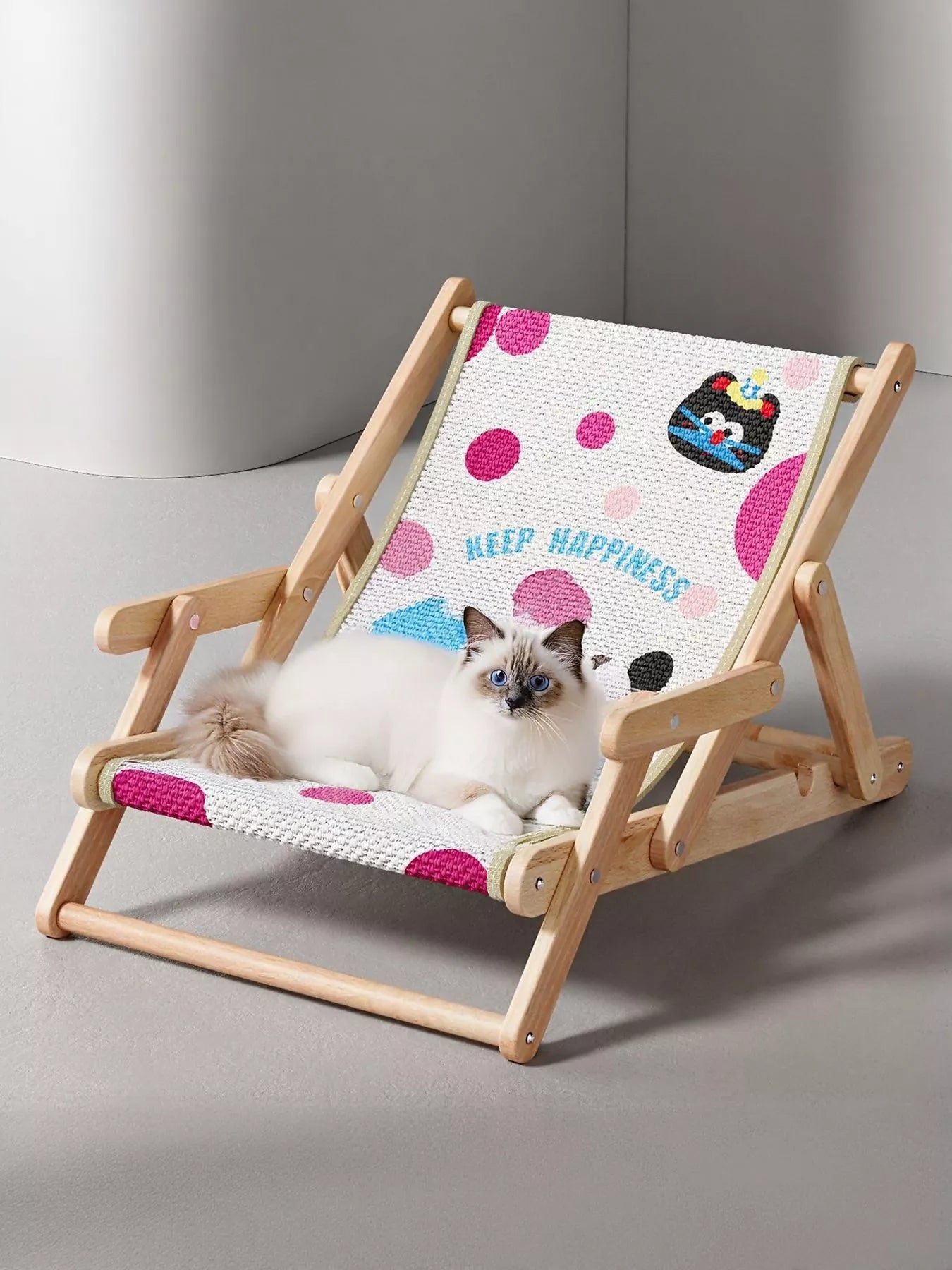 Wooden pet chair with polka dot black cat pattern, featuring a lying kitten