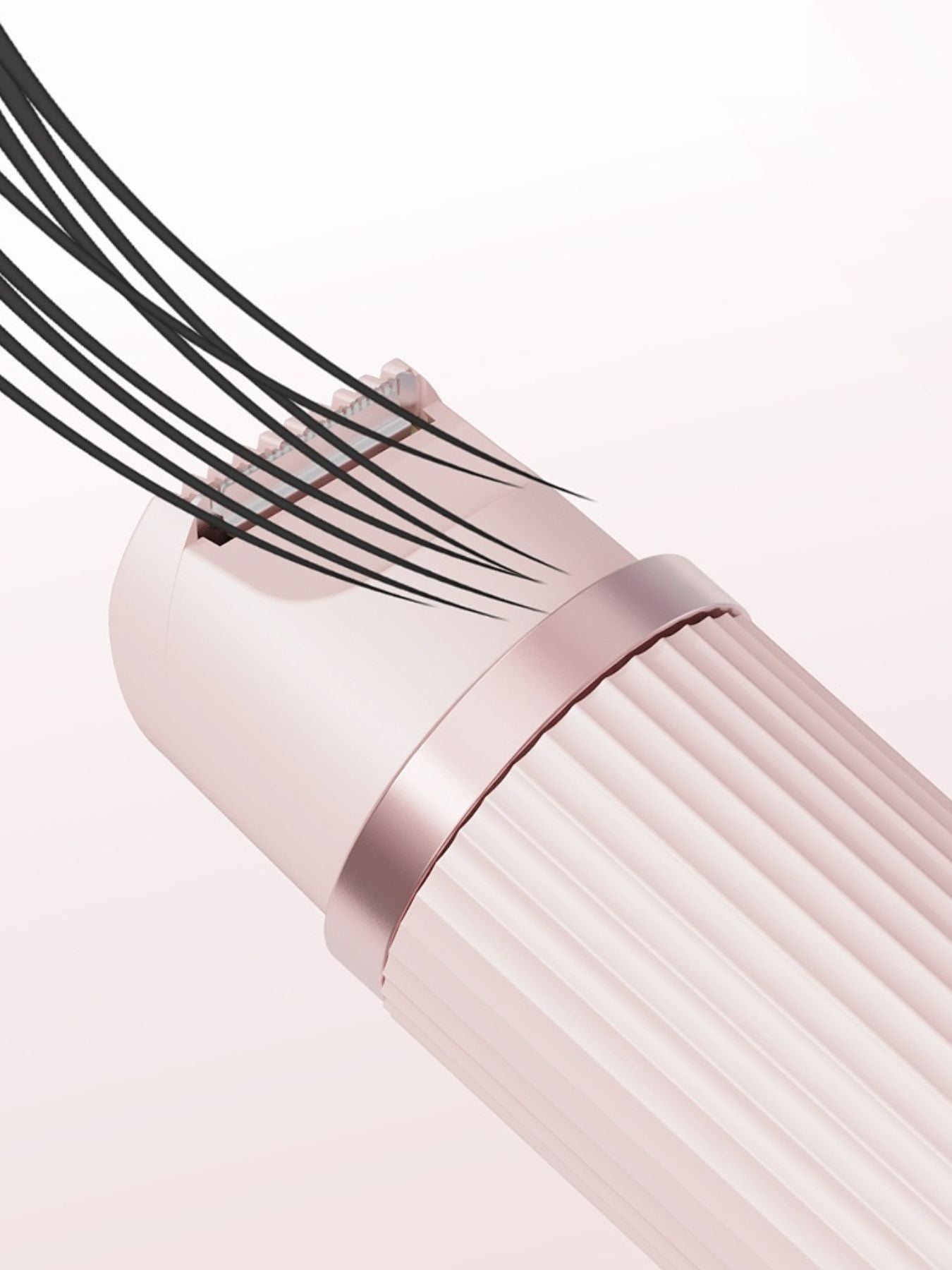 Close-up of blush pink epilator head area with textured drum rollers