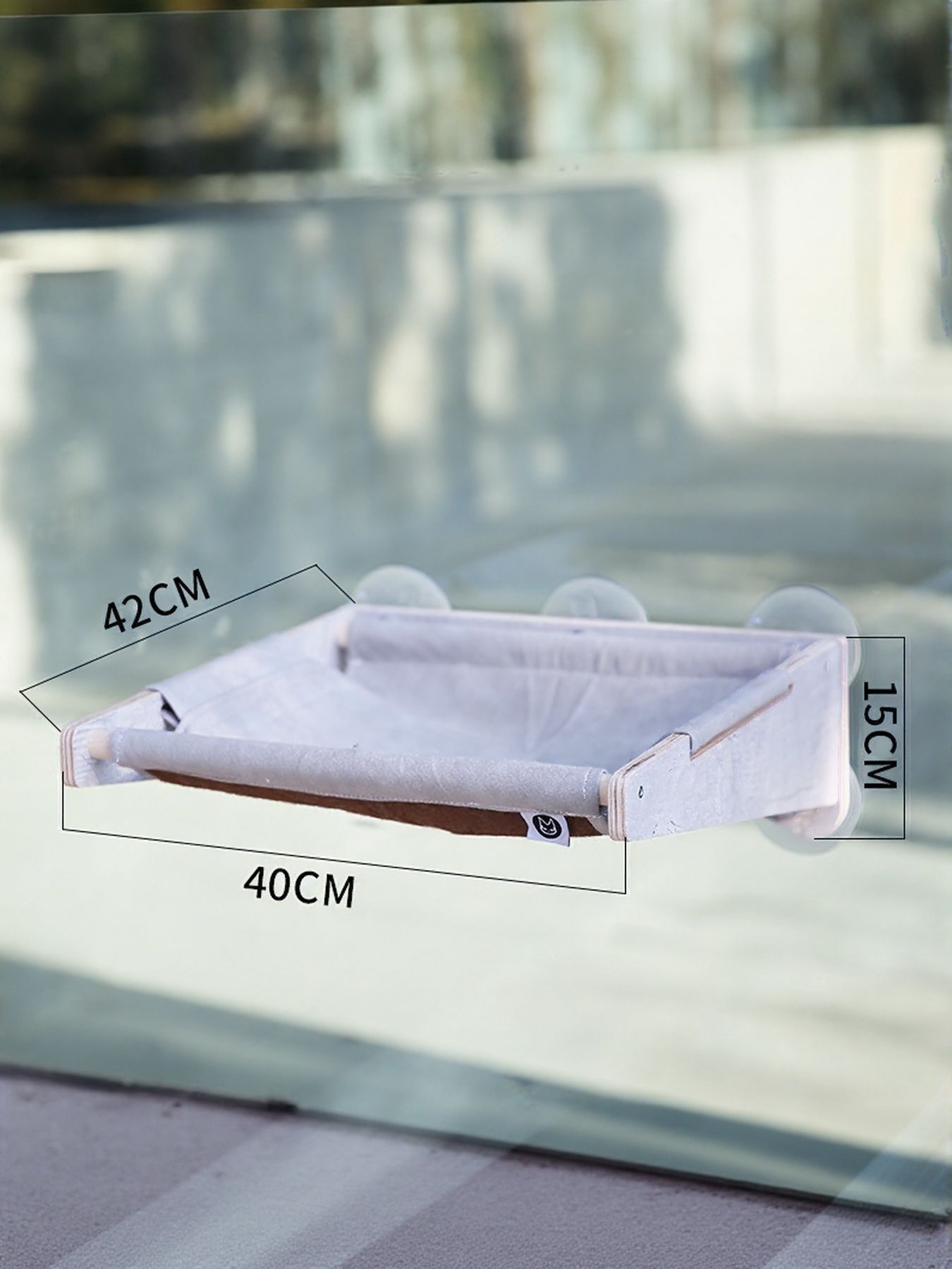 Window-mounted cloth hammock bed with white cushion and size measurements, 42cm by 40cm