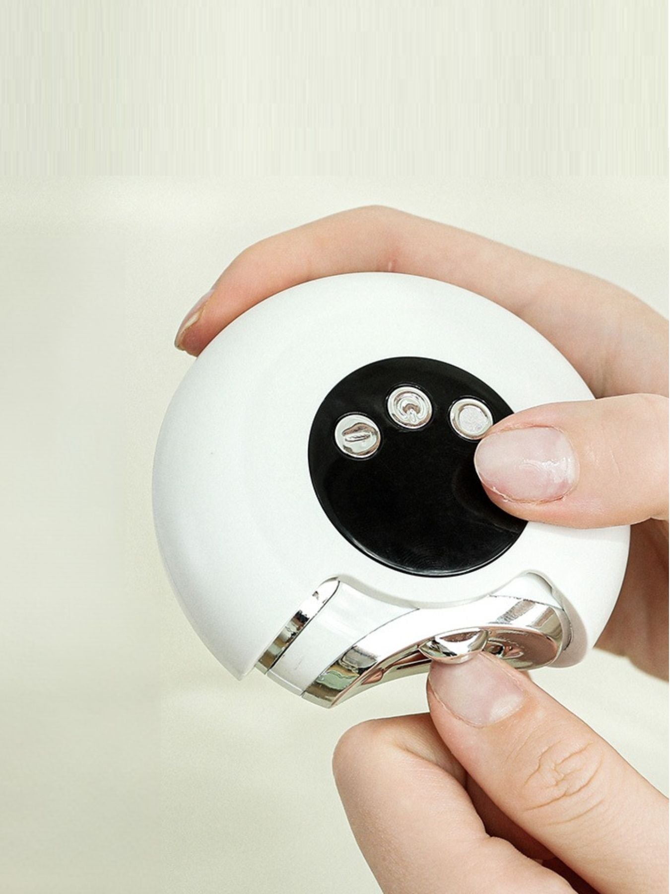 Portable nail buffer polisher, white round body with metal head and button controls