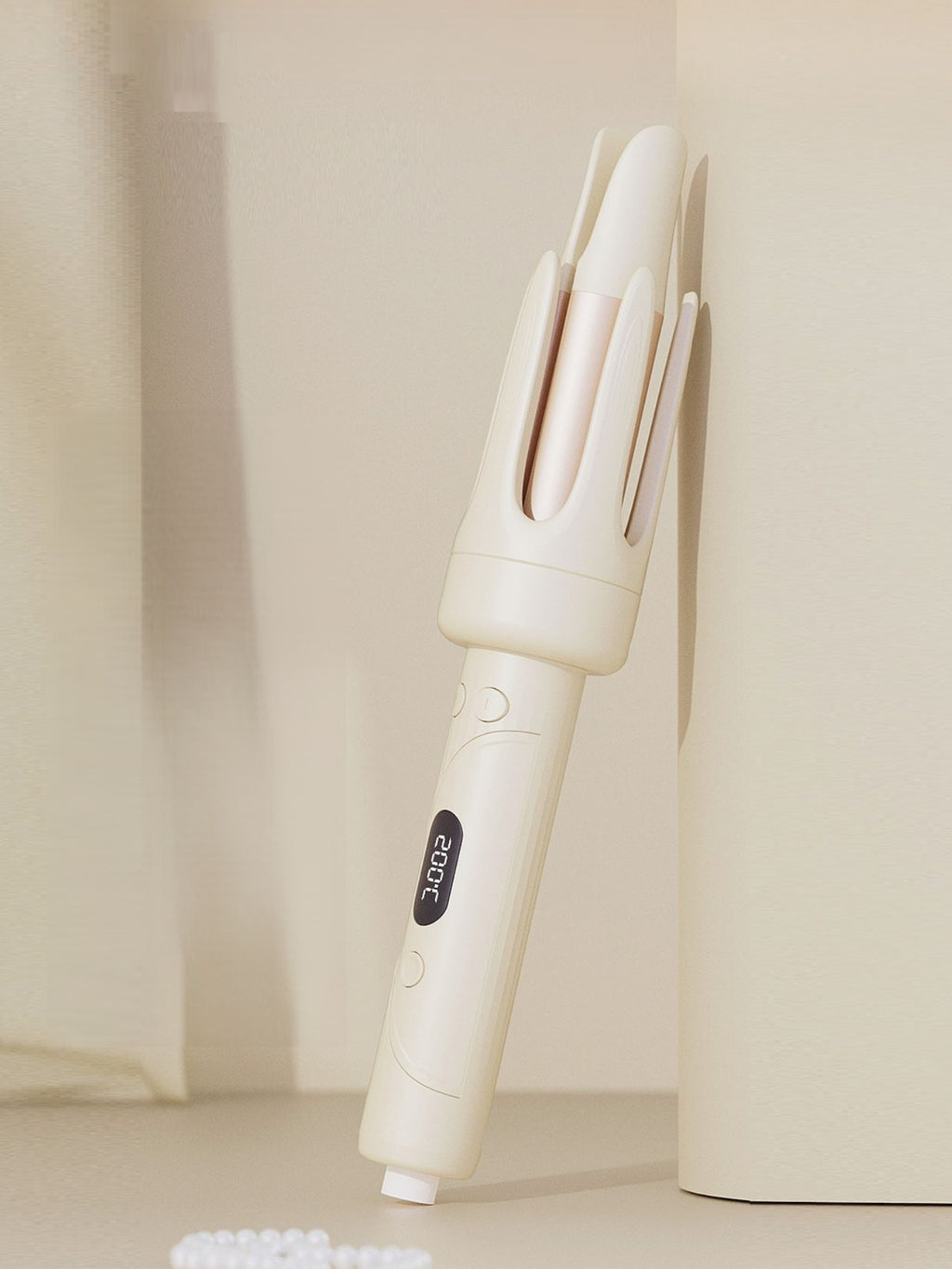 Beige automatic hair curling iron angled view showing three barrels and side controls