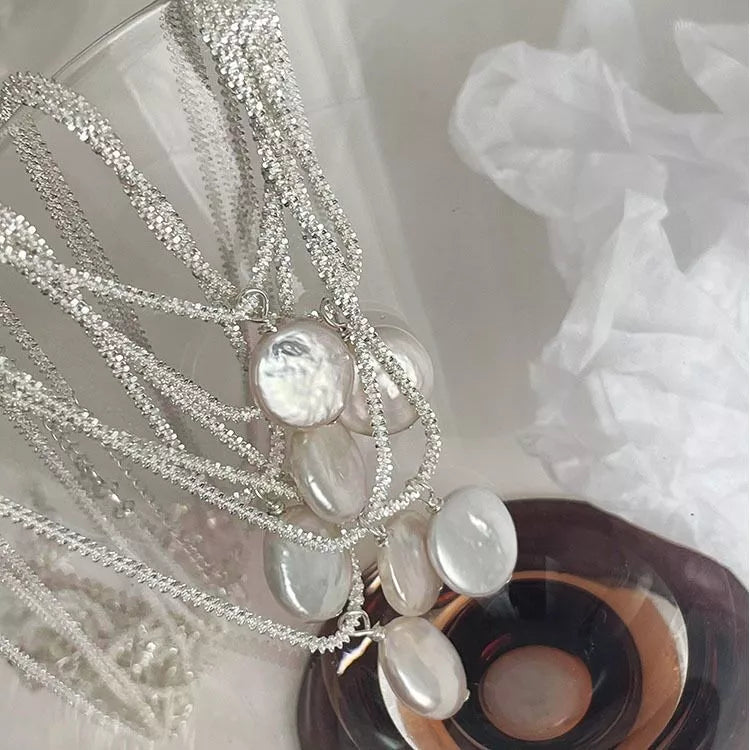 Multiple round pearl charms on silver chain, styled necklace set