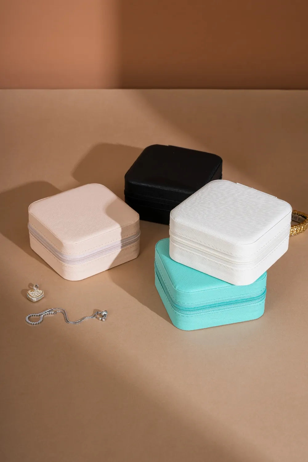 PU leather square jewelry boxes in turquoise, white, and black with hinged lids