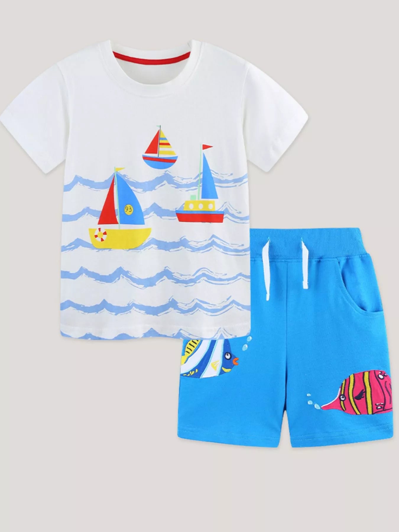 White T-shirt with red and blue sailboat graphic; matching blue drawstring shorts