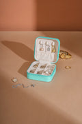 Turquoise PU leather square jewelry box open with ring and earring compartments