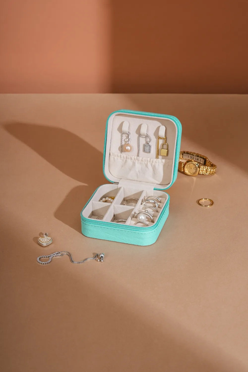 Turquoise PU leather square jewelry box open with ring and earring compartments