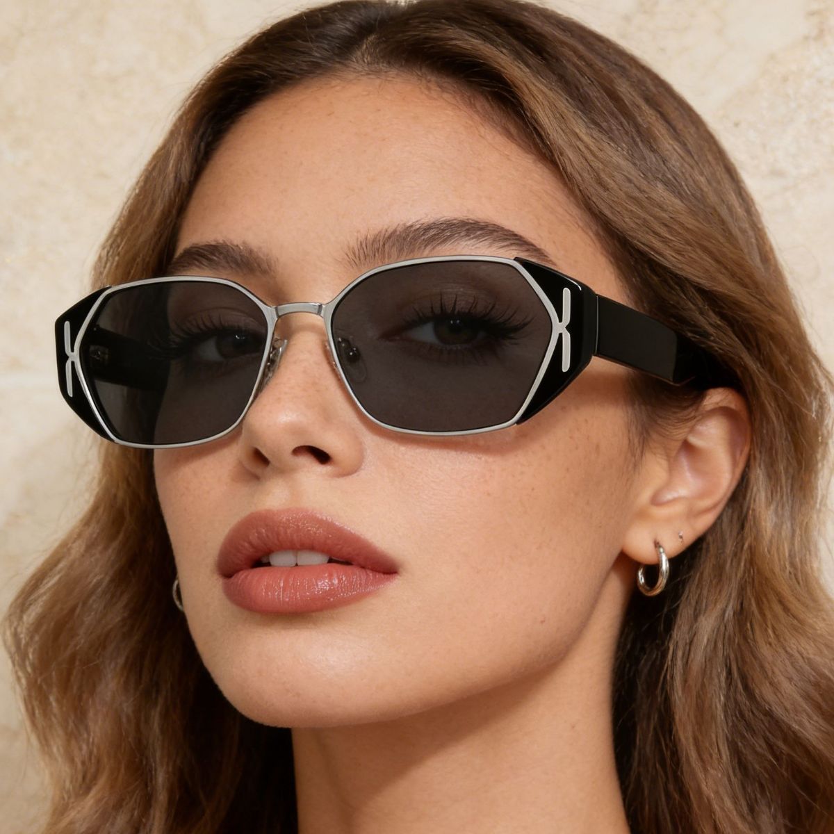 Black geometric UV sunglasses, angled view with dark lenses and curved arms.