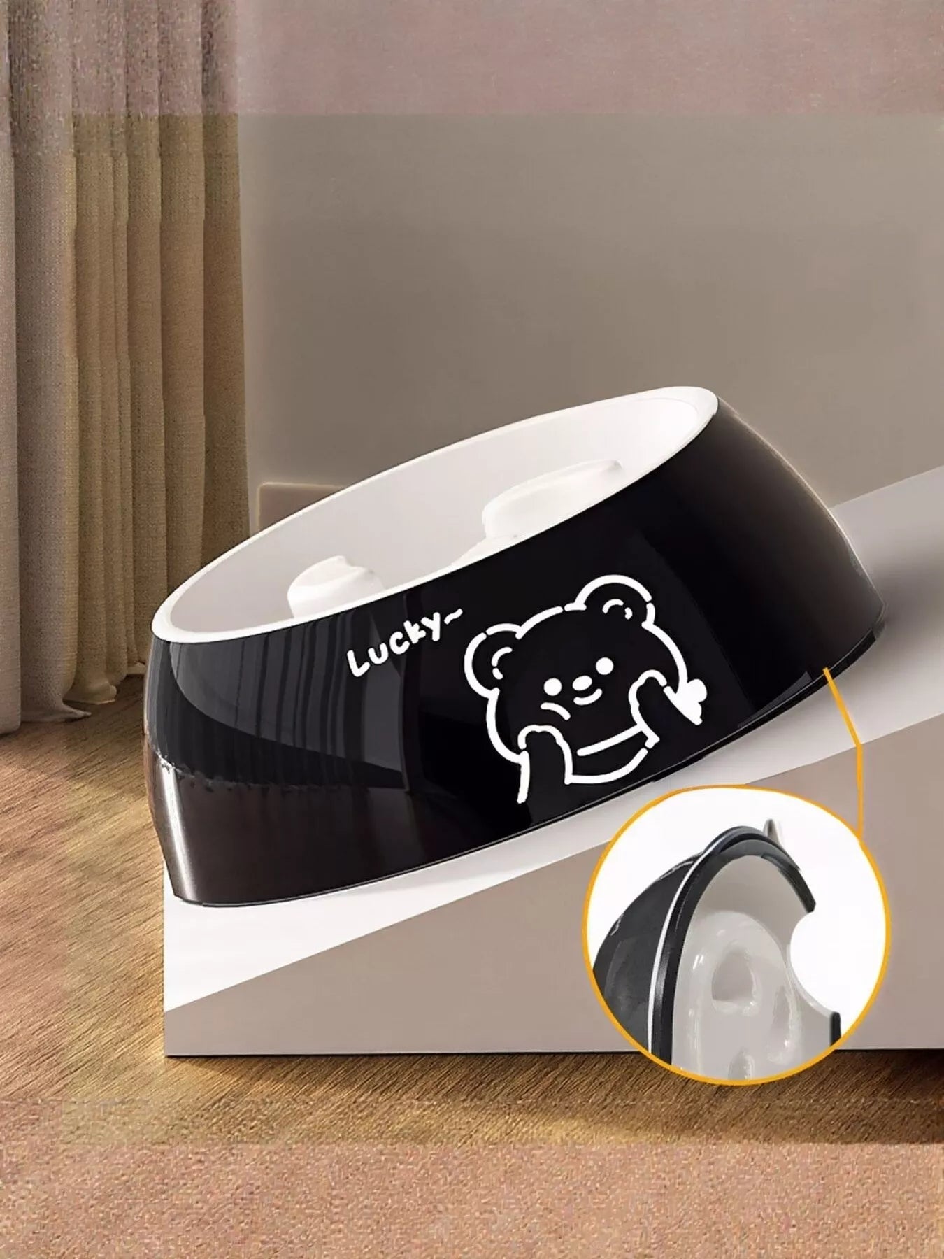 Black pet bowl with bear face graphic and white inner insert