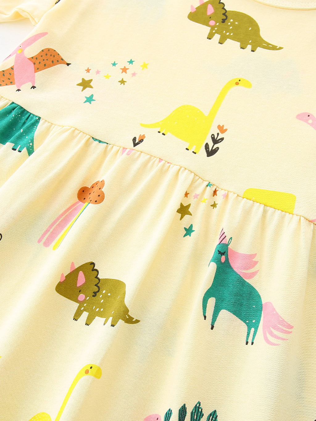Pastel yellow dress bodice and skirt with colorful dinosaur graphics and elastic waist
