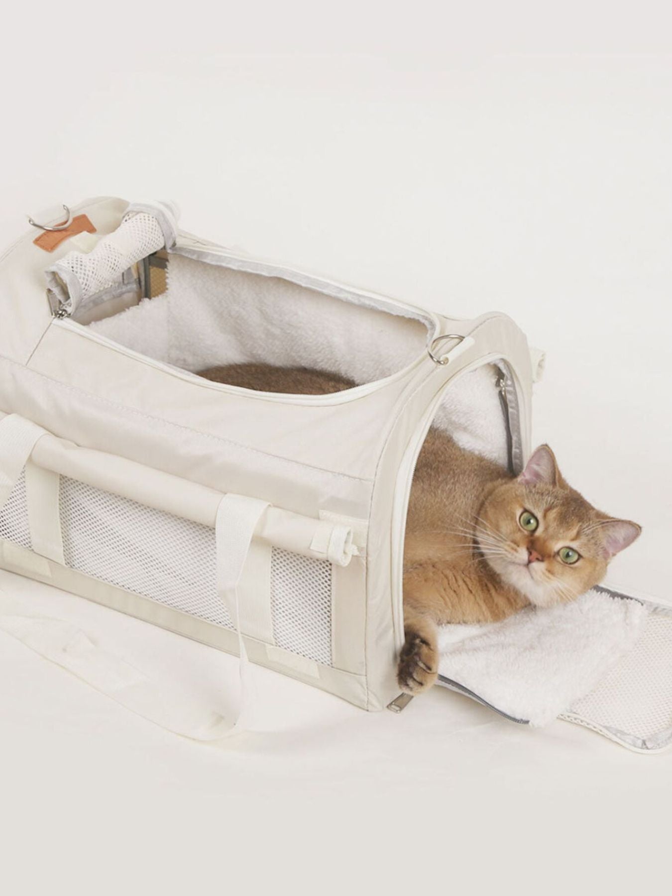 Pet carrier bag with liner insert, open side panel and plush interior, white.