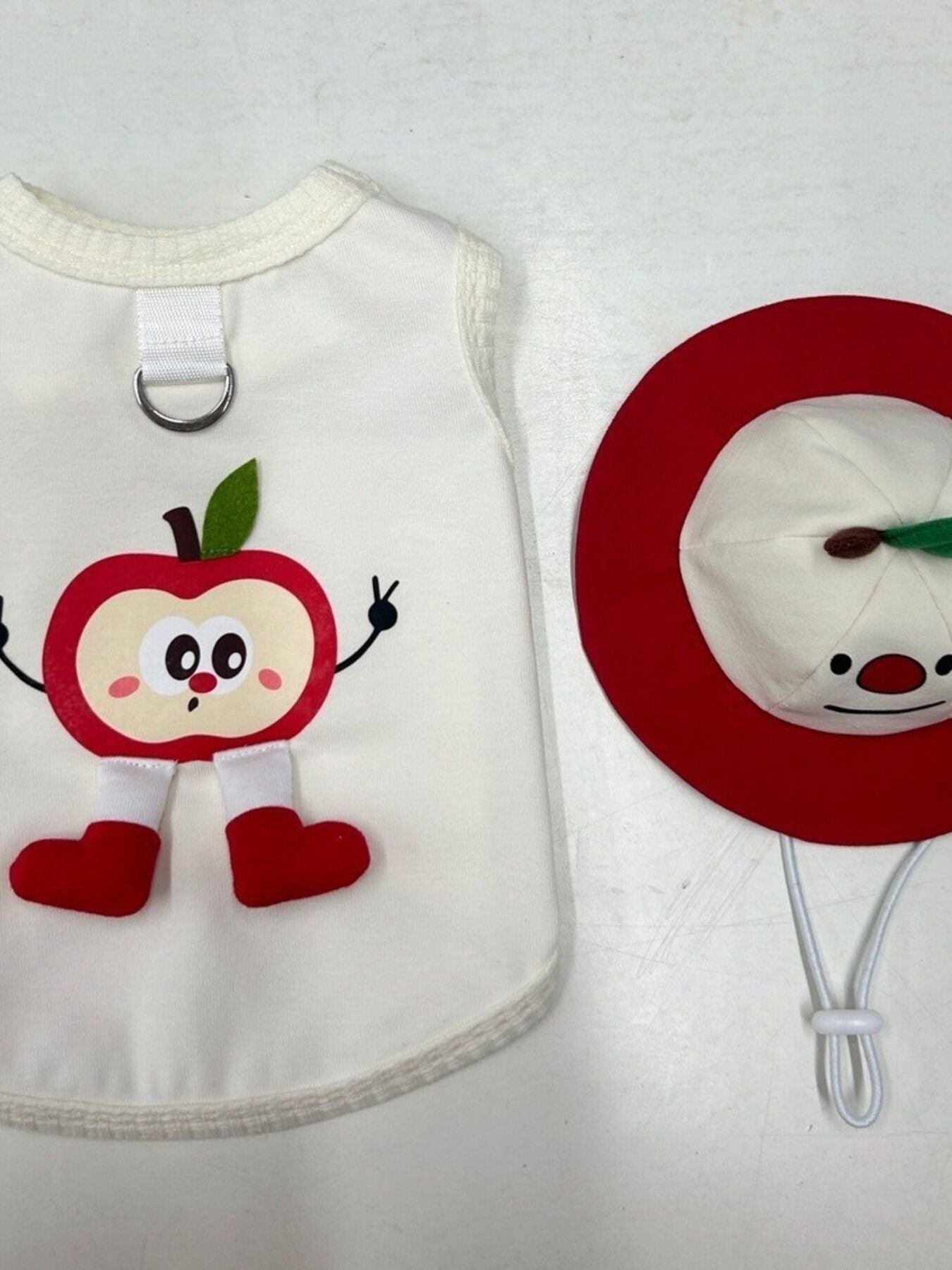 White pet tank with red apple character patch and metal collar ring