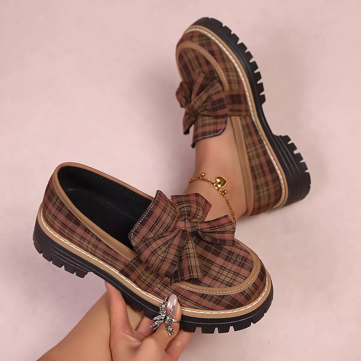 Tan plaid bow loafers with round toe, contrast stitching, and chunky black sole