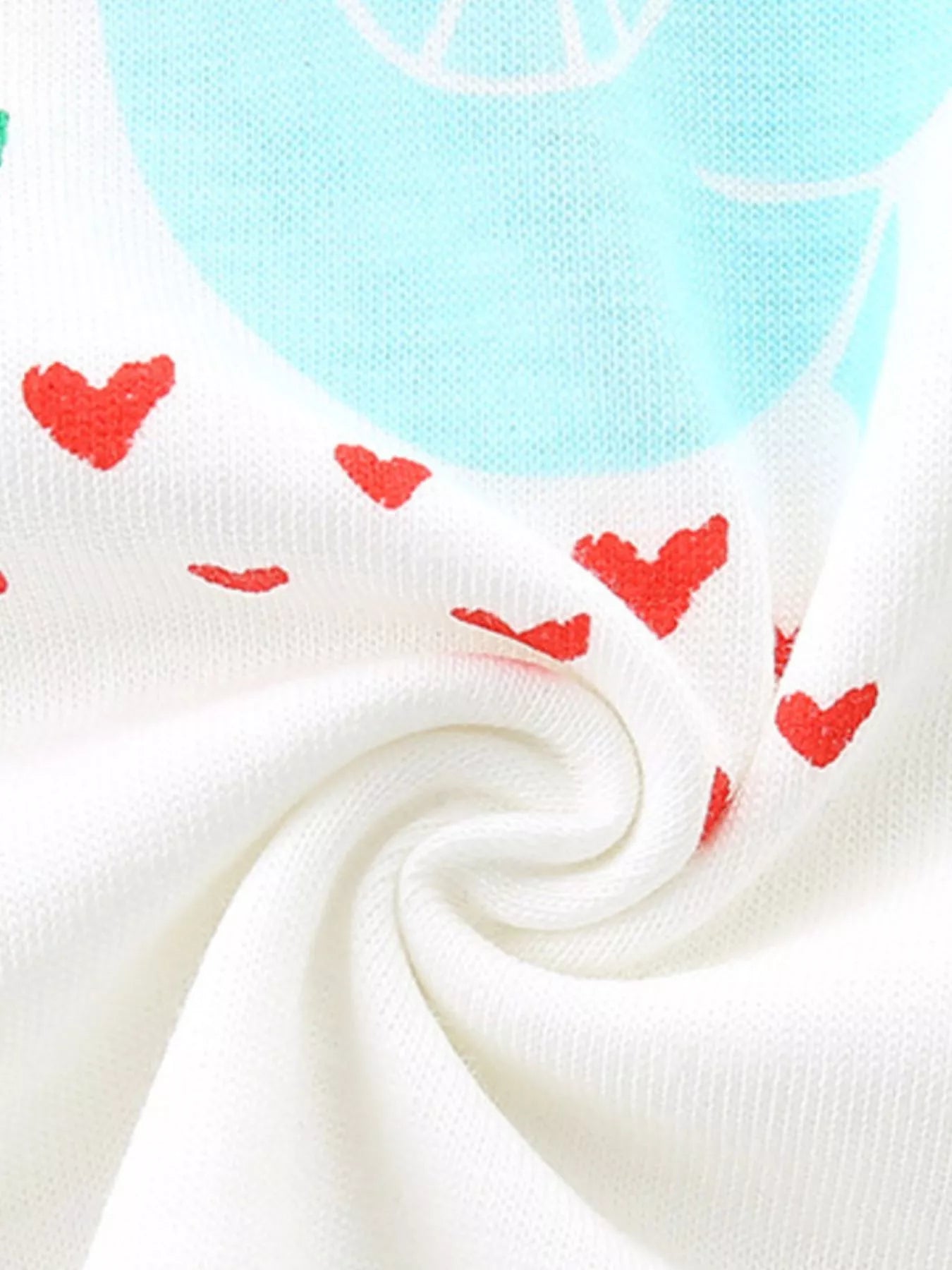 White knit fabric with small red heart print