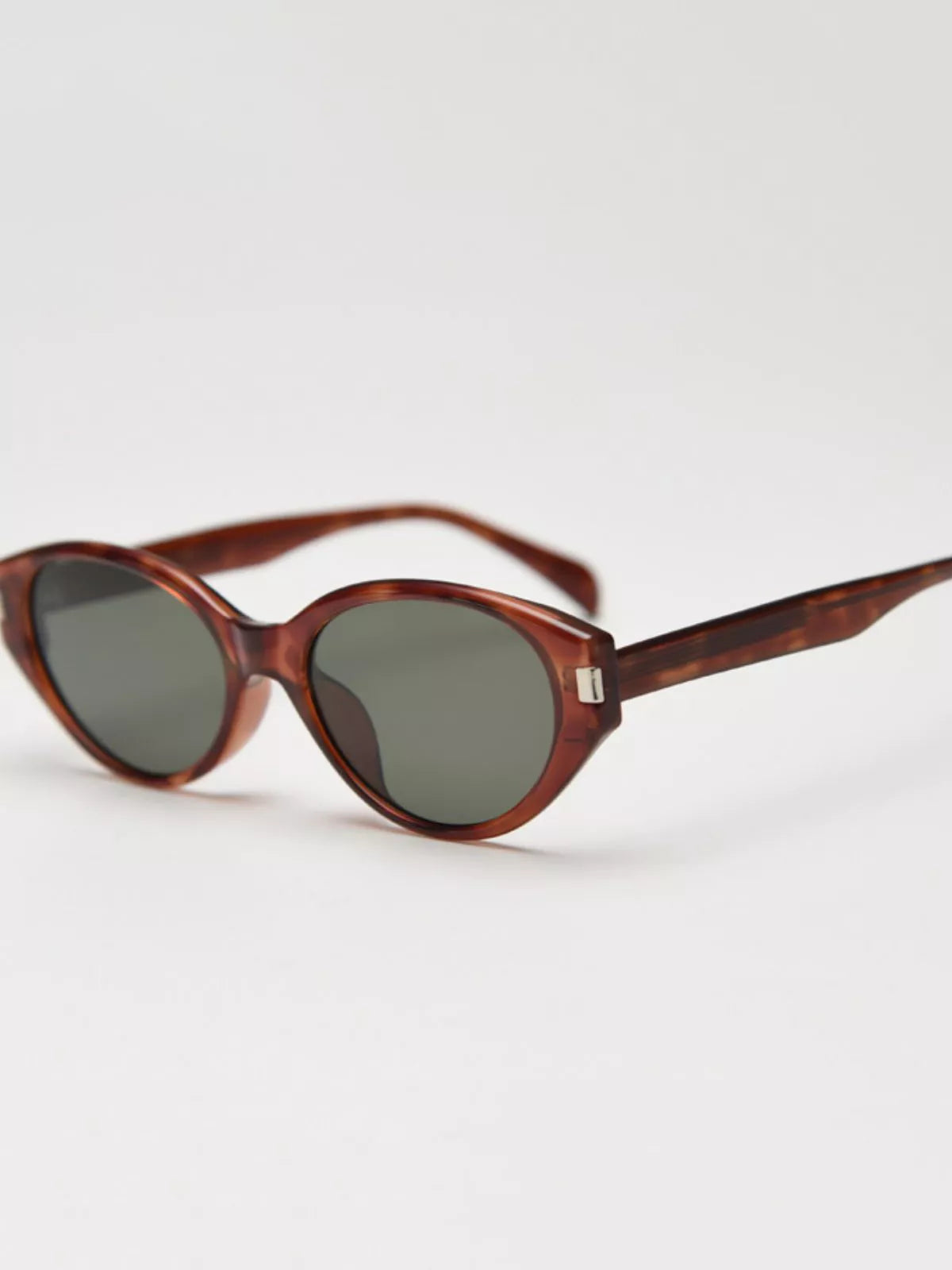 Tortoiseshell cat-eye sunglasses with dark oval lenses and thin temples