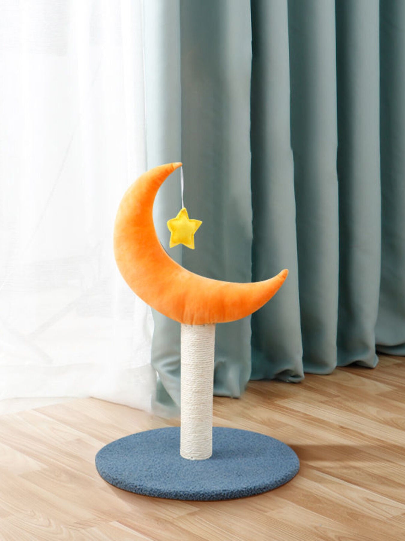 Orange moon cat scratching post with yellow star toy on circular blue base