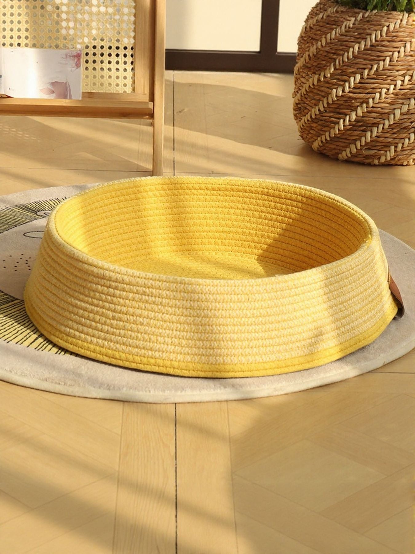 Woven rattan pet nest with yellow woven round basket and beige base cushion