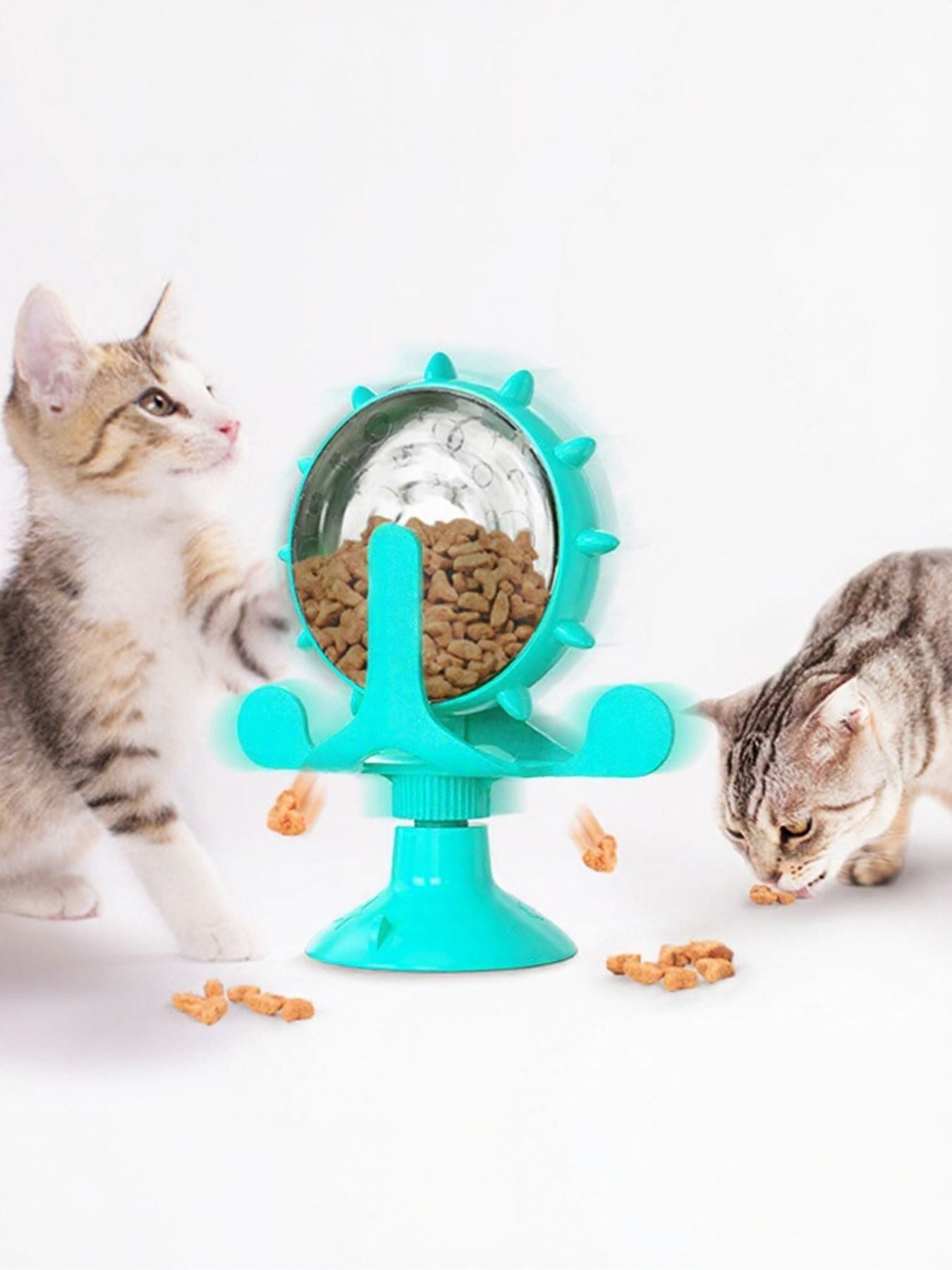 Interactive rotating cat treat toy with clear dome, teal arms, and teal base