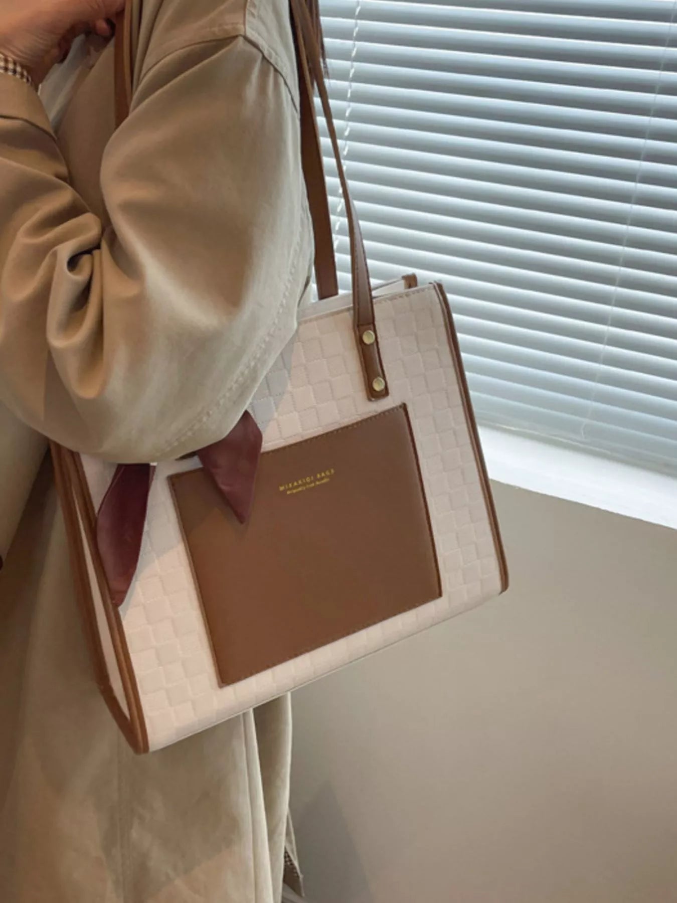 White quilted shoulder bag with brown front panel, gold button details