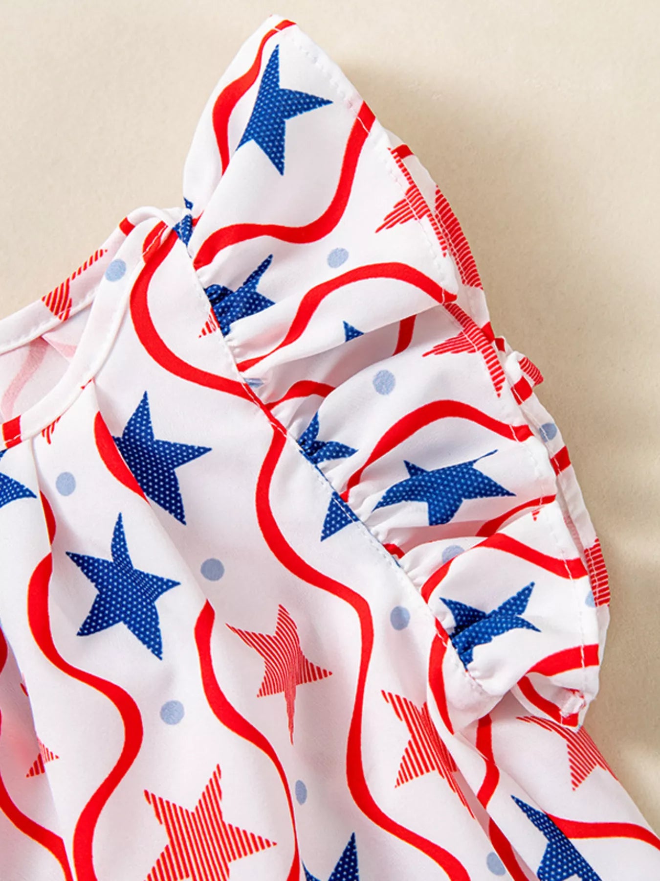 Ruffled short sleeve on patriotic star-print dress with blue red star swirls