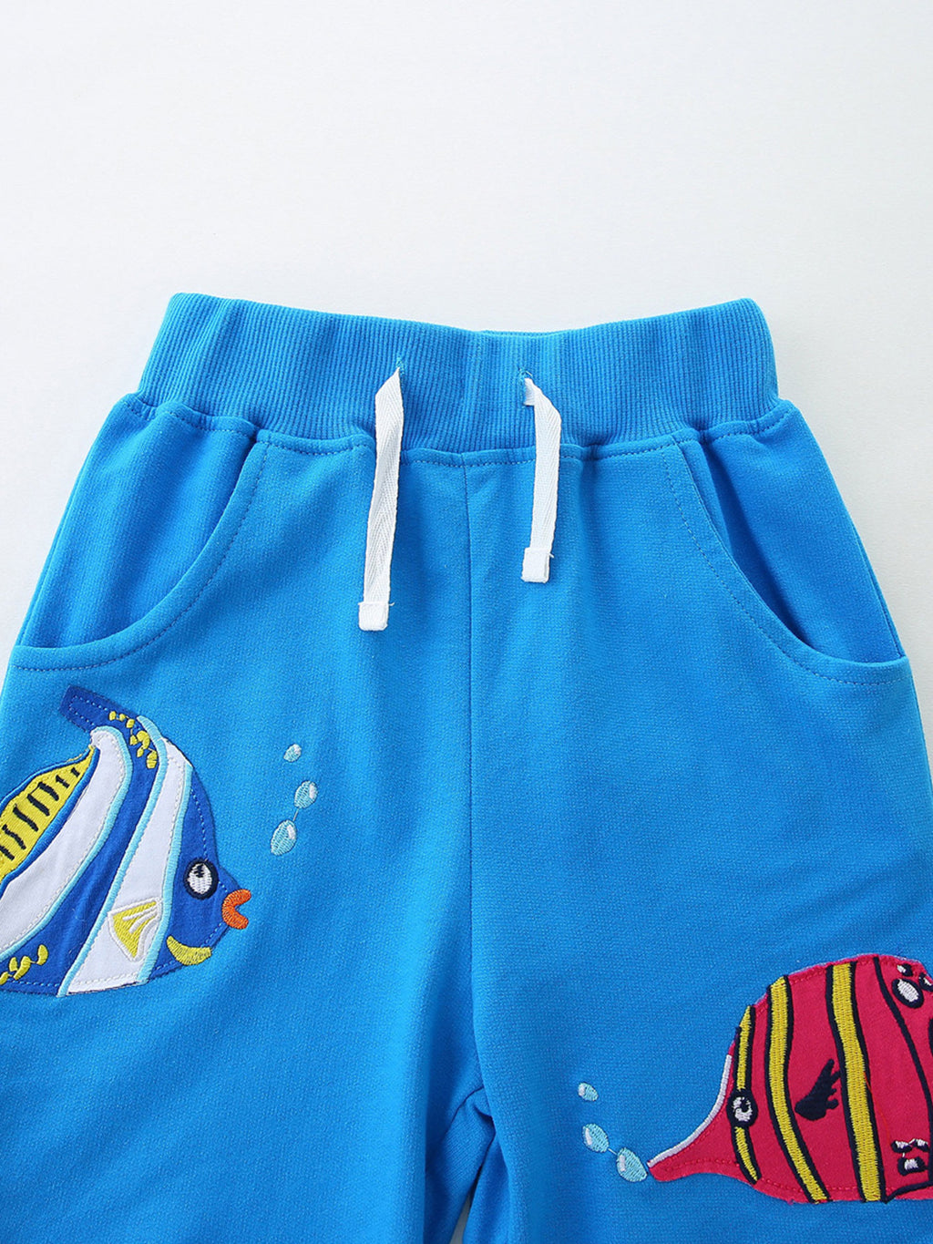 Bright blue shorts: elastic waistband with white drawstring and fish print panels