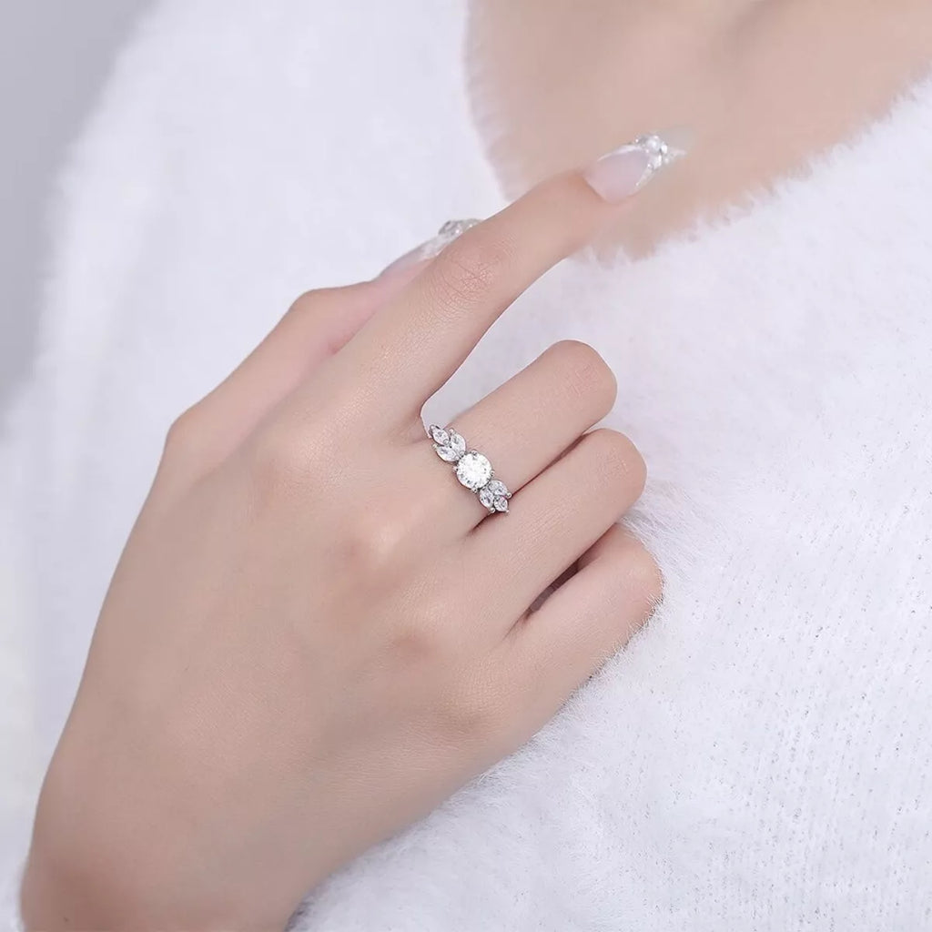 Moissanite ring with three oval stones on 925 sterling silver band, worn on hand