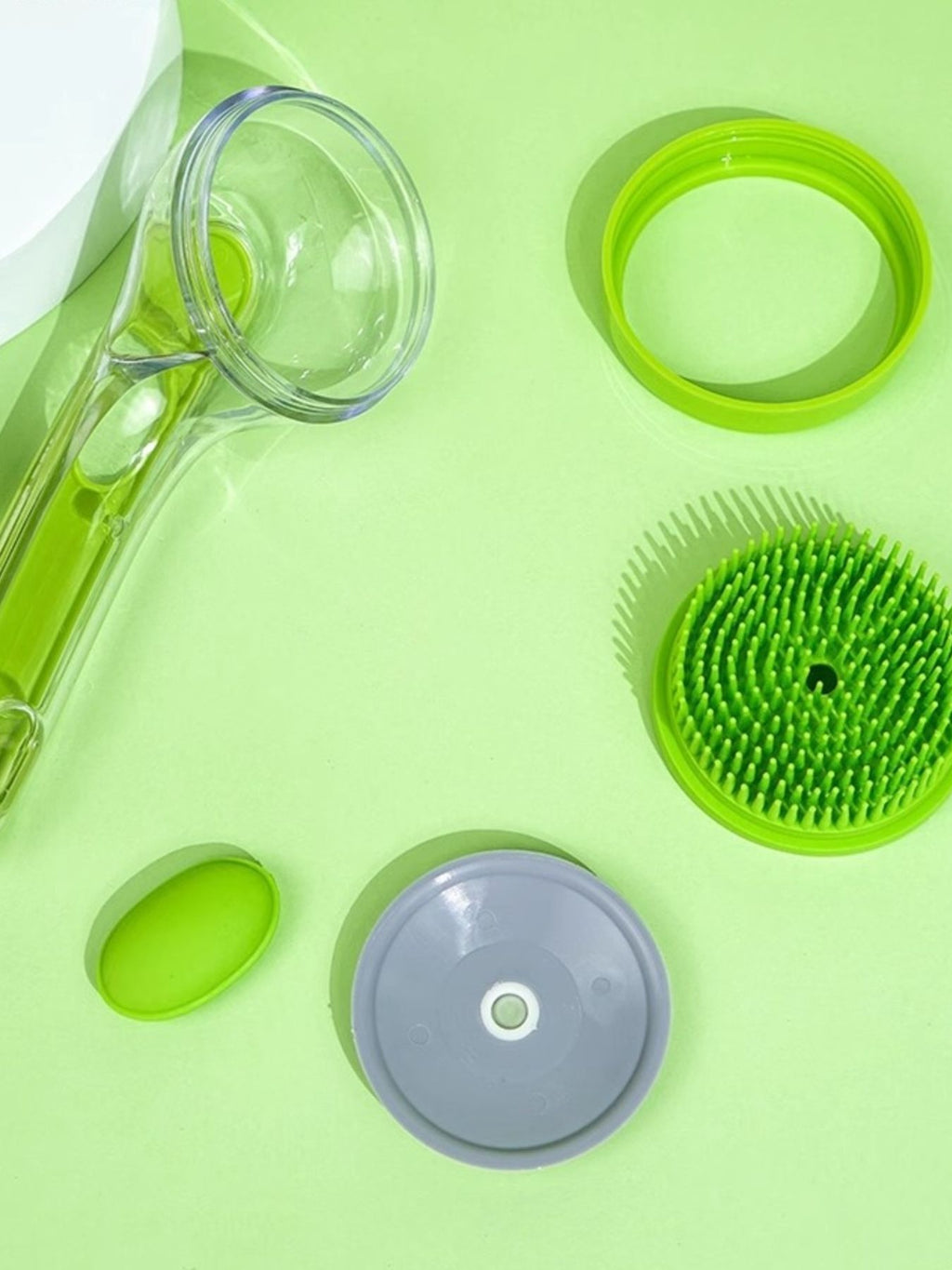 Soft Pet Shower Brush parts: green cap, clear tube, and gray base with bristles