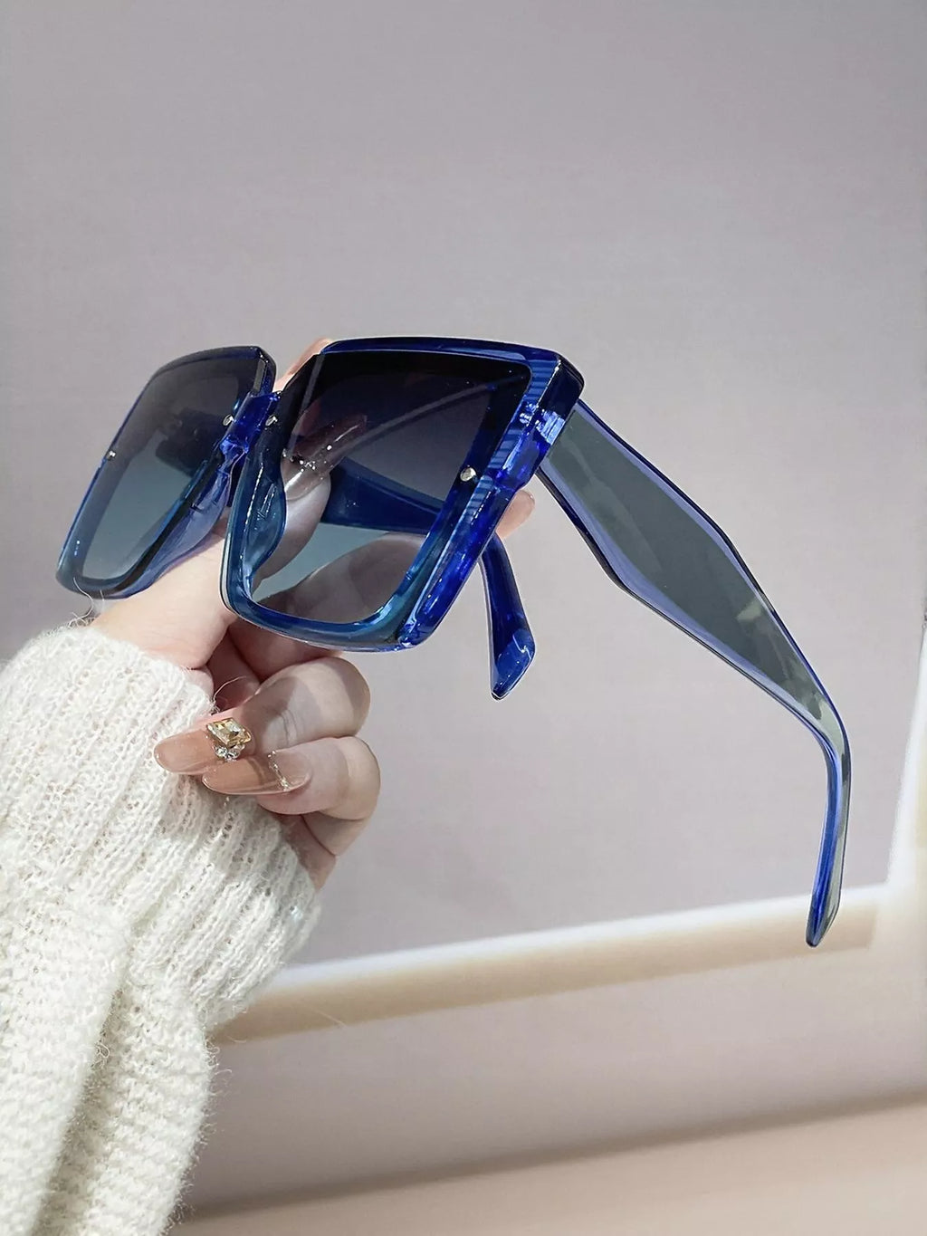 Blue oversized square sunglasses, side profile with glossy temple