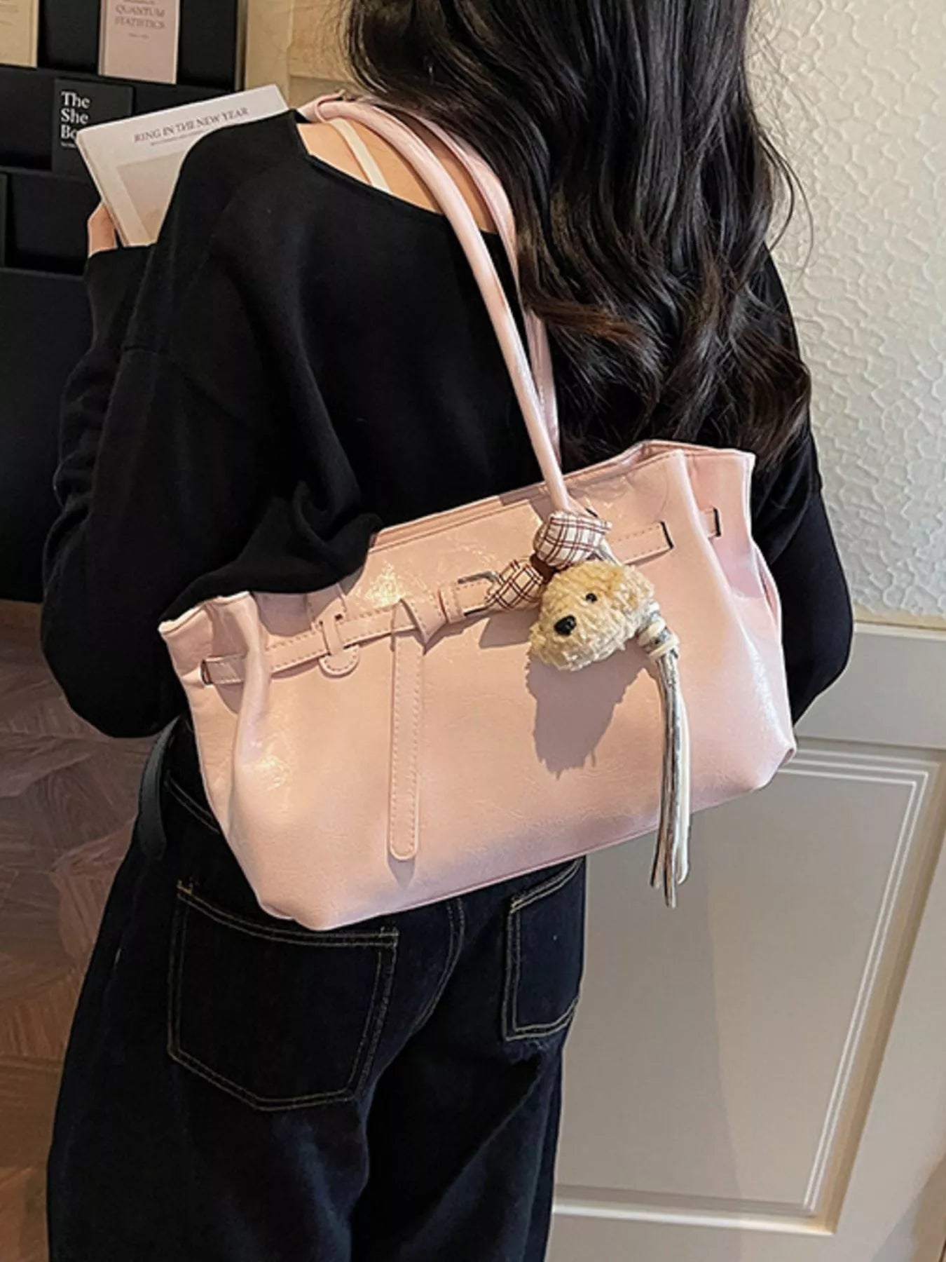 Blush pink shoulder bag with dog charm and plaid bow, glossy leather finish