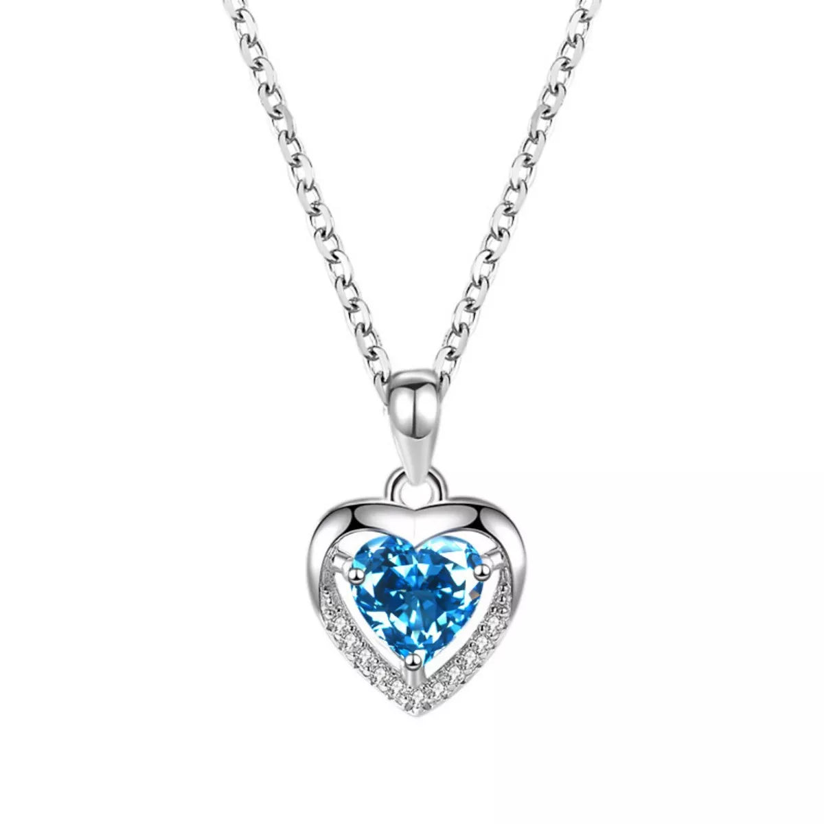 Silver heart pendant close-up with light blue zircon and pavé halo frame