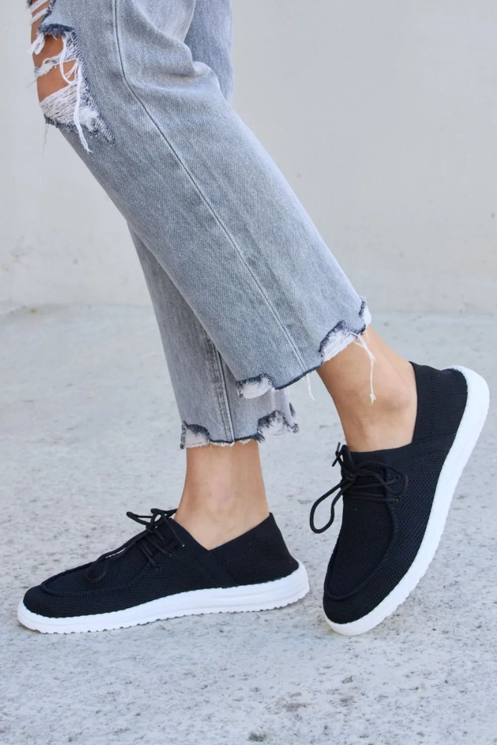 Black knit-look lace-up sneakers with round toe and white sole