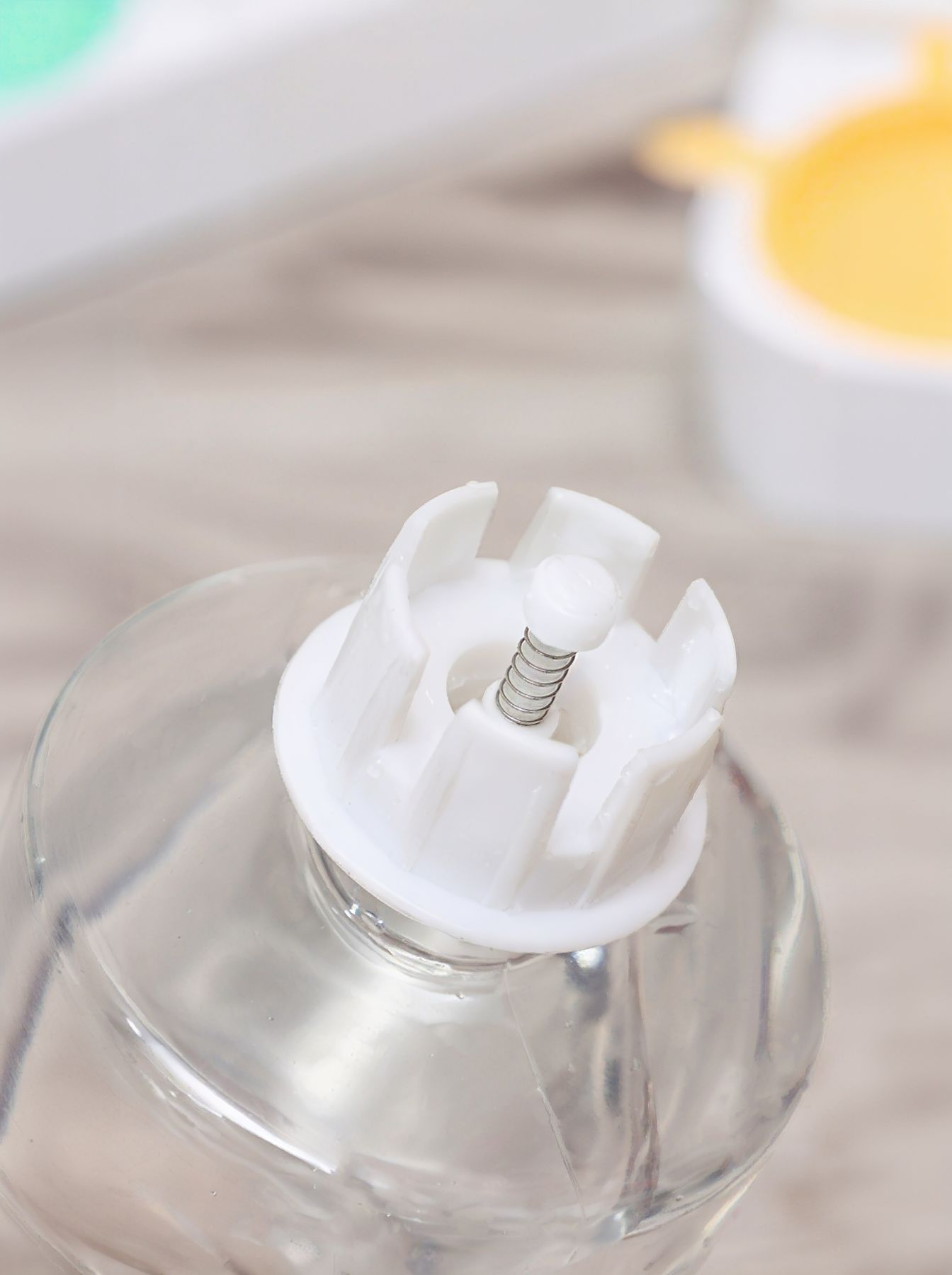 Clear water container with white float and spring mechanism for automatic dispenser.