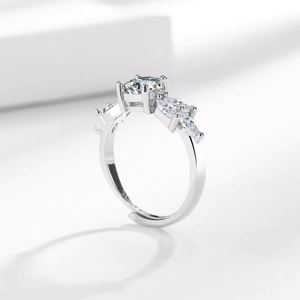 925 sterling silver moissanite ring angled view, marquise and pear stones in prong setting