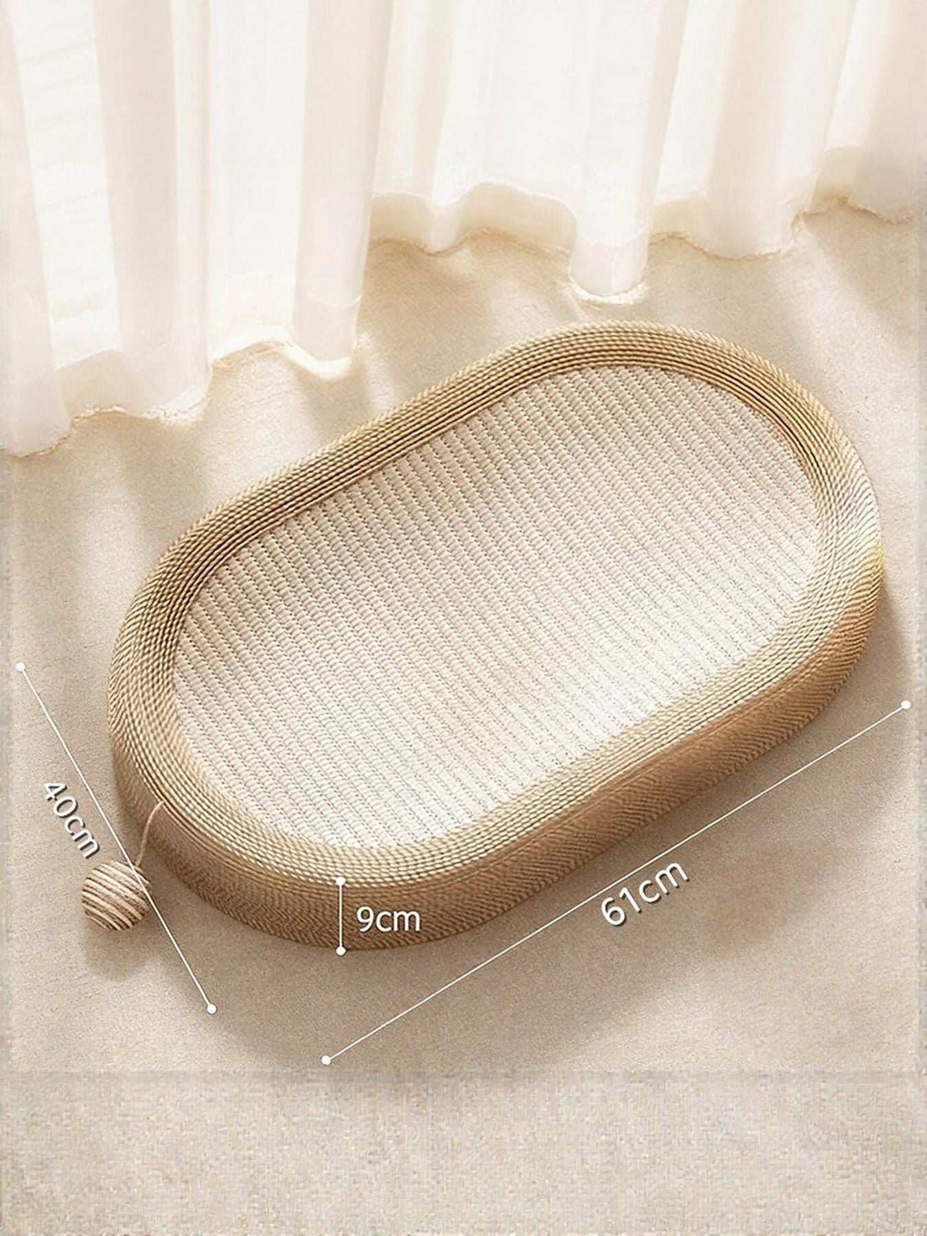 Beige oval cat scratching bed with textured weave and small rope ball attachment