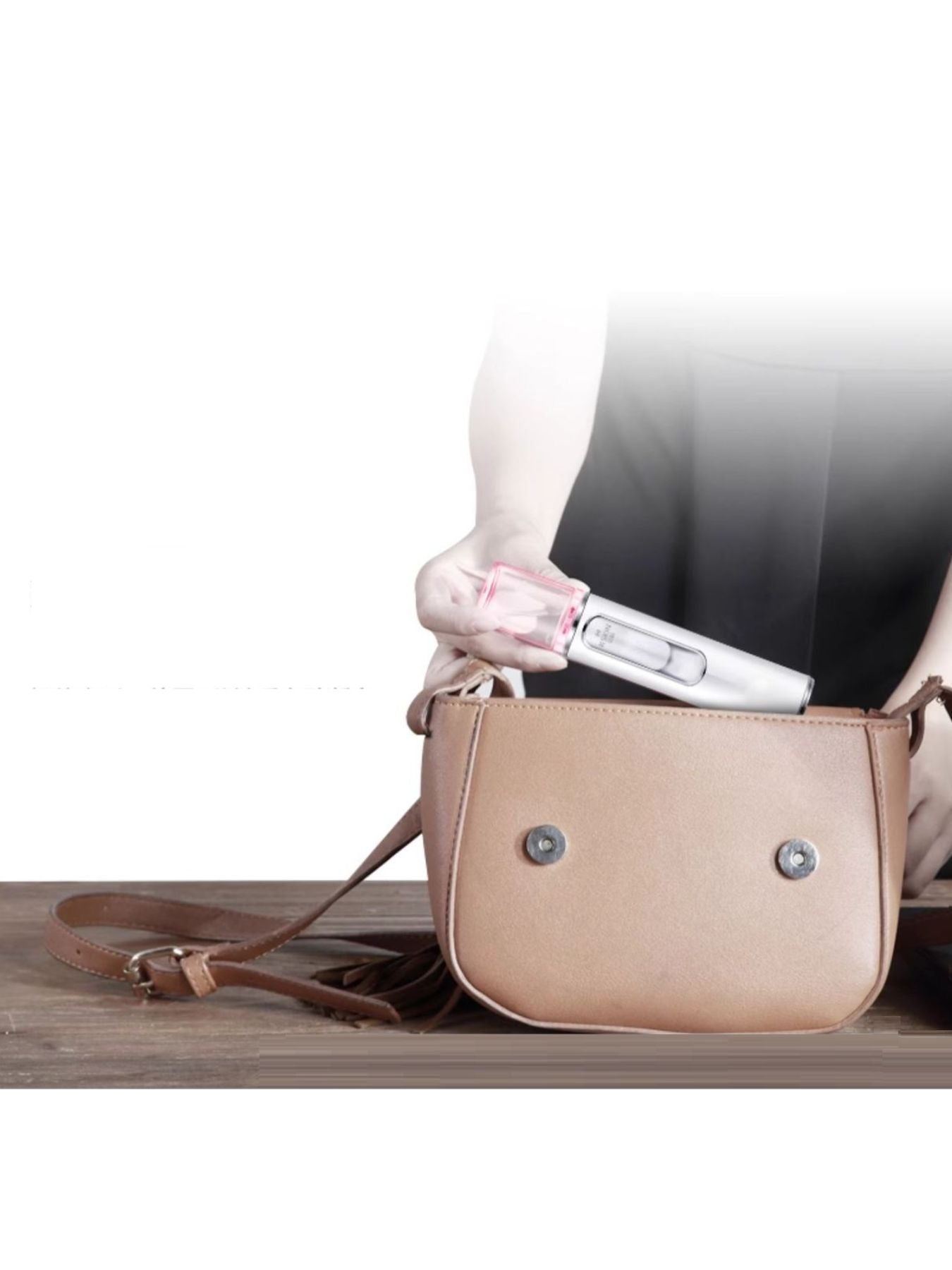 Portable facial mister sprayer clipped inside small handbag