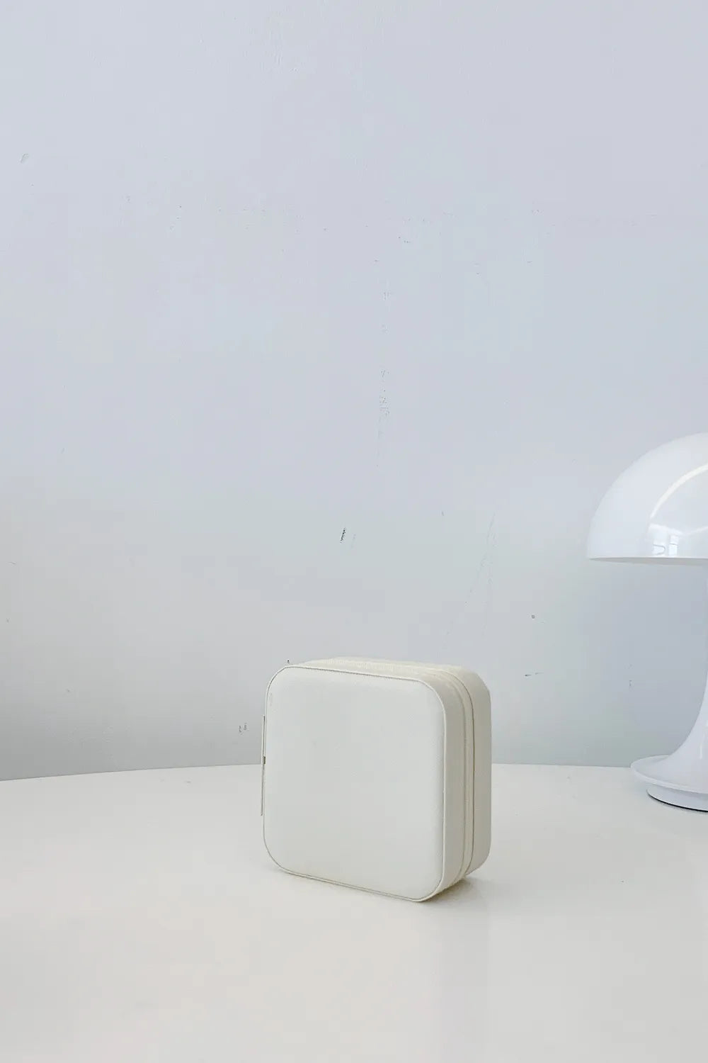 White PU leather square jewelry box, closed with rounded corners and stitched trim