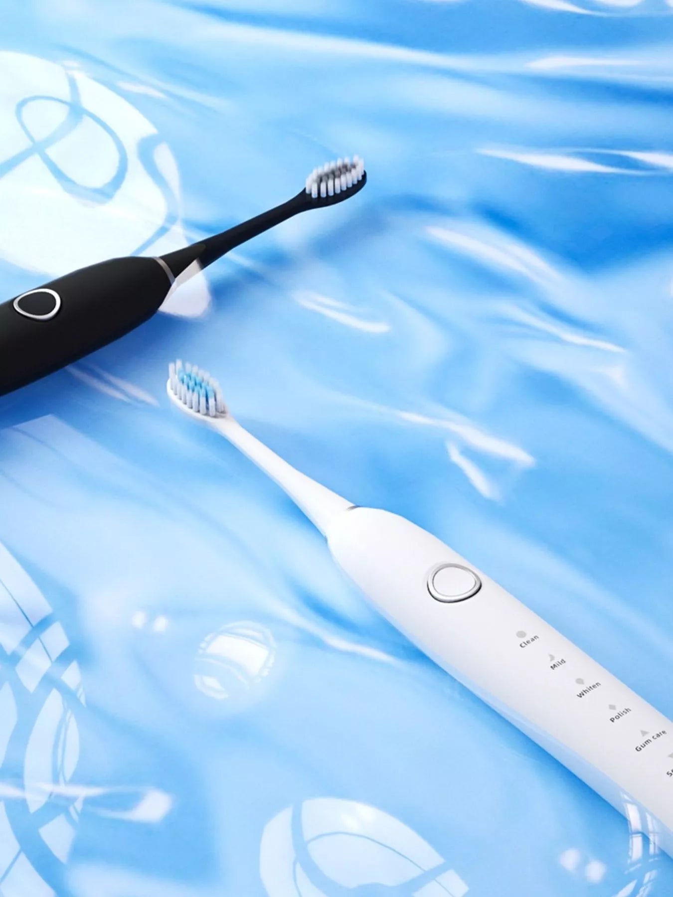 Black and white electric toothbrushes showing multi-mode buttons on handles