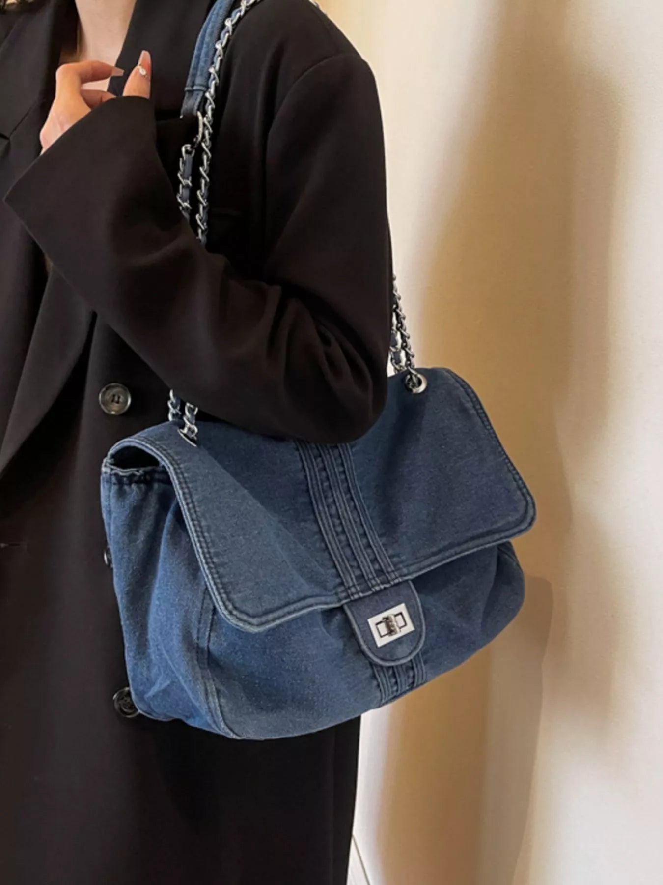 Blue denim flap shoulder bag with chain strap and front clasp detail