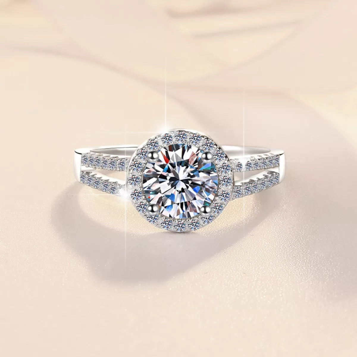 Round moissanite halo center with pavé accents on split-style silver band