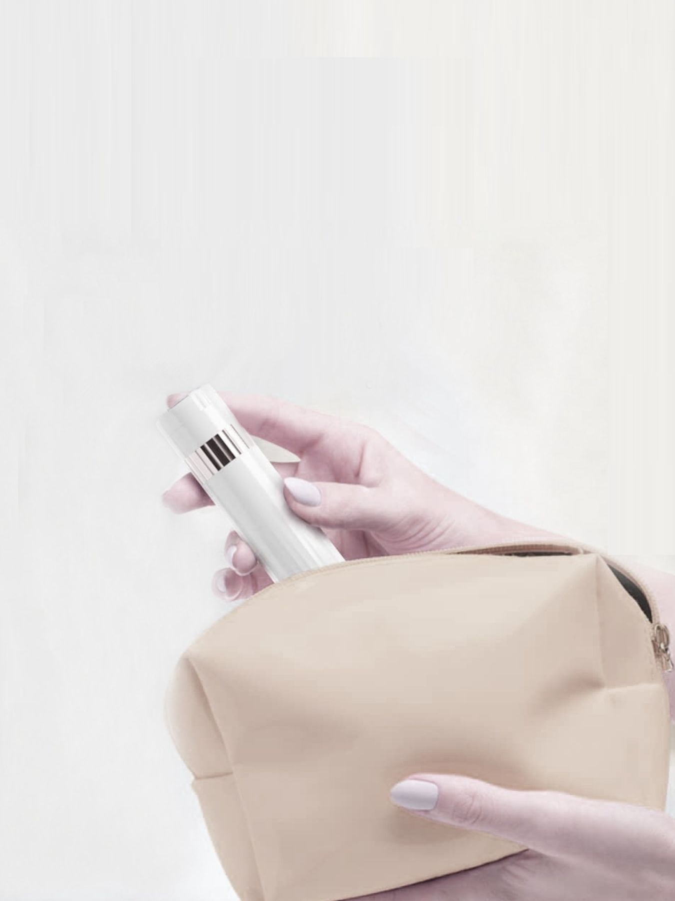White electric epilator held in hand with small attachment piece