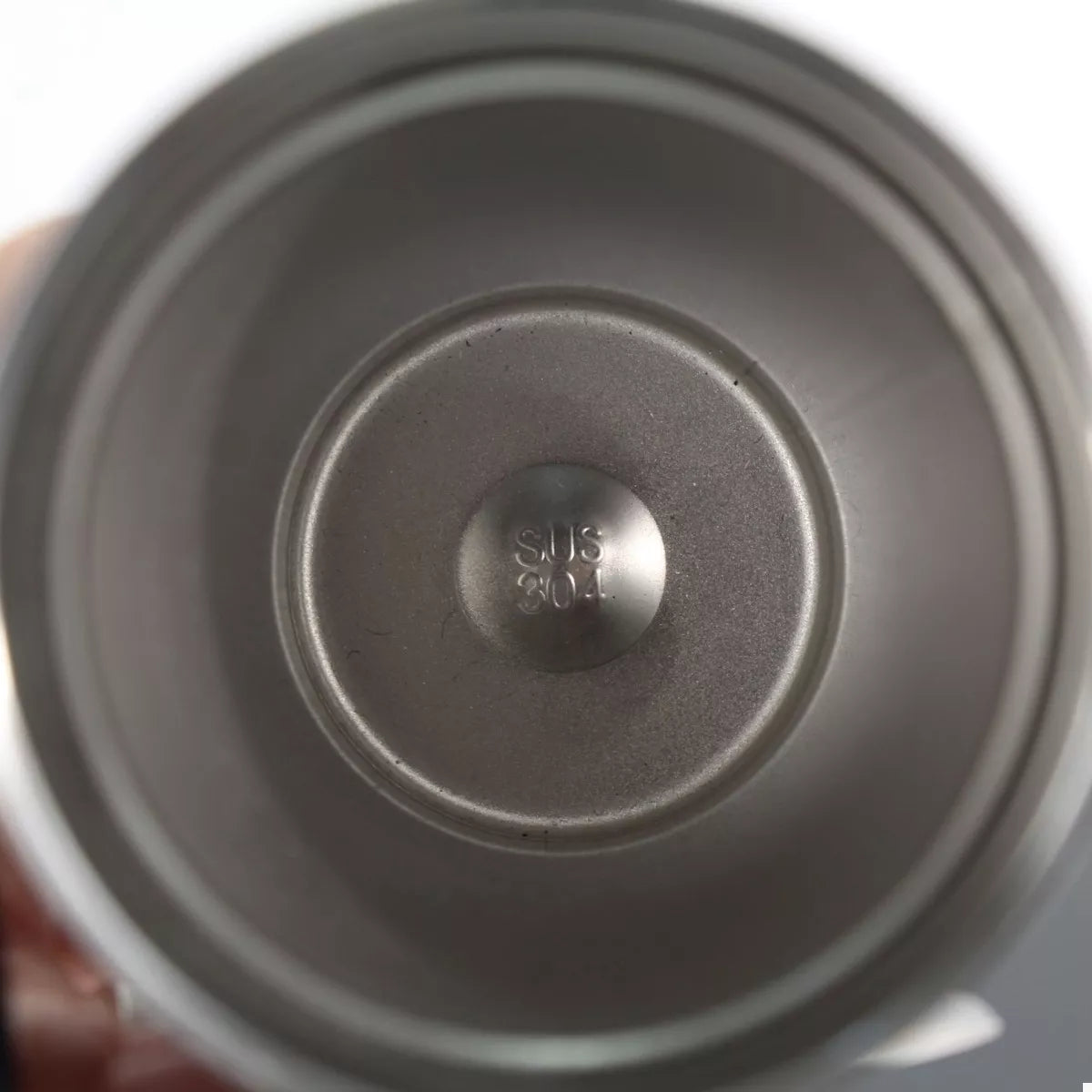 Stainless steel tumbler bottom showing “SUS 304” label